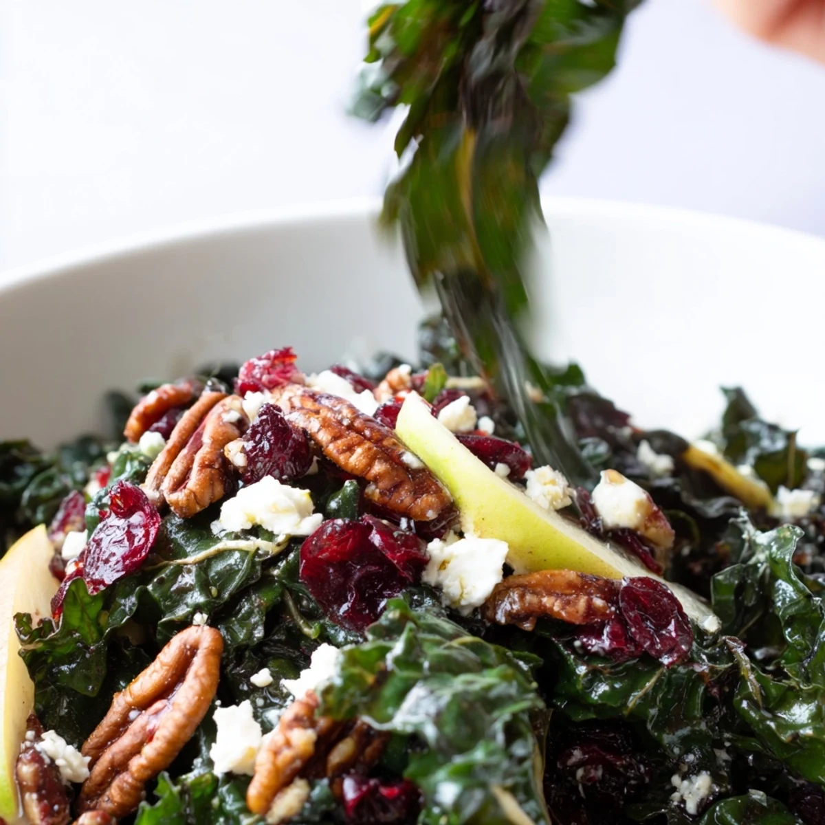 Vibrant vegetarian Winter Kale Salad topped with apple cider vinaigrette and toasted walnuts, perfect for easy gluten-free meal prep or a bright seasonal side dish.