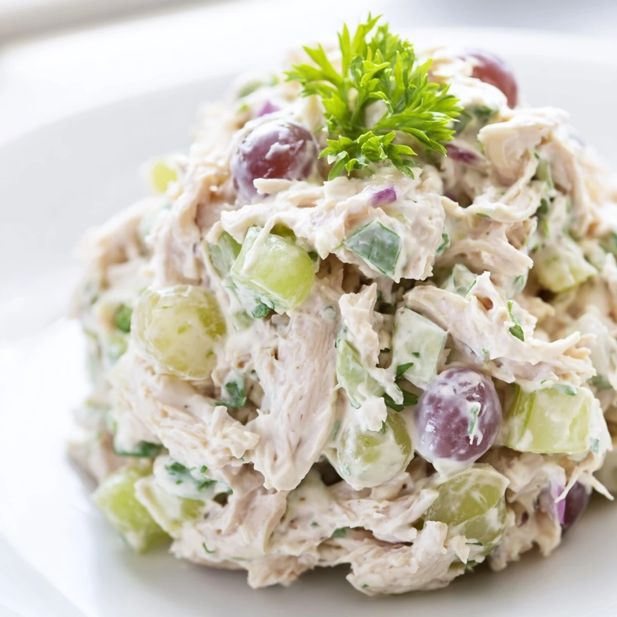 Bright and fresh Chicken Salad Scoop in a crisp lettuce cup, garnished with chopped parsley, ready for a light gluten-free lunch.