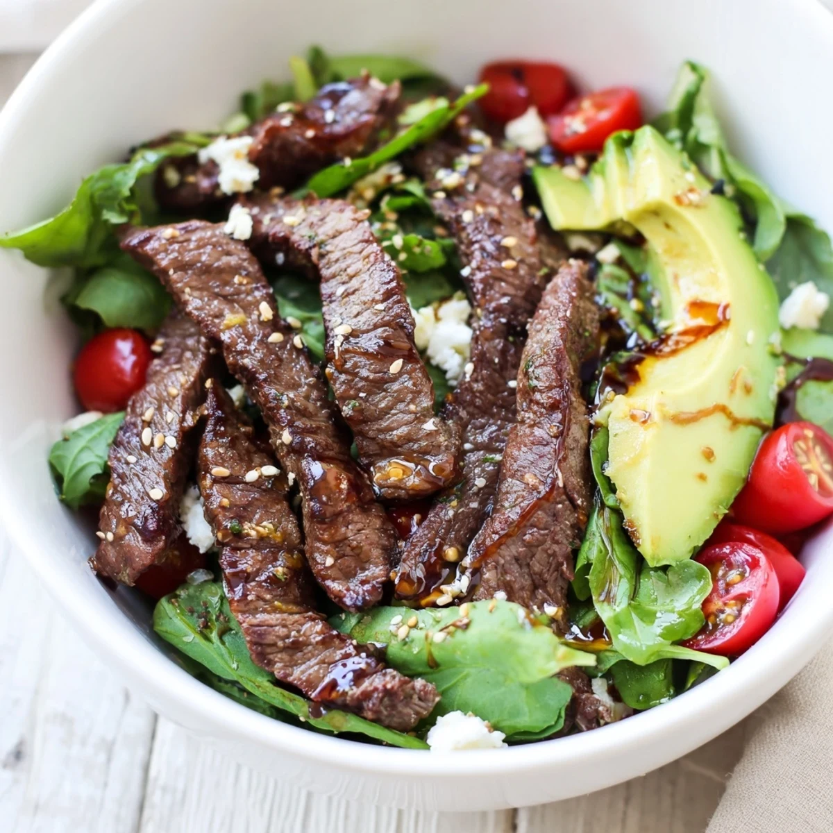 Hearty Beef Salad Bowl with crisp romaine, julienned carrots, and sesame seeds, ready to serve for a quick and healthy dinner.
