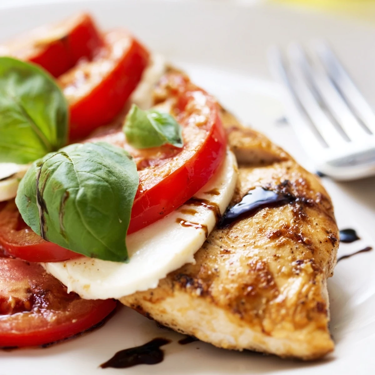 Freshly baked Caprese Stuffed Chicken Breast garnished with basil, served beside a crisp garden salad.
