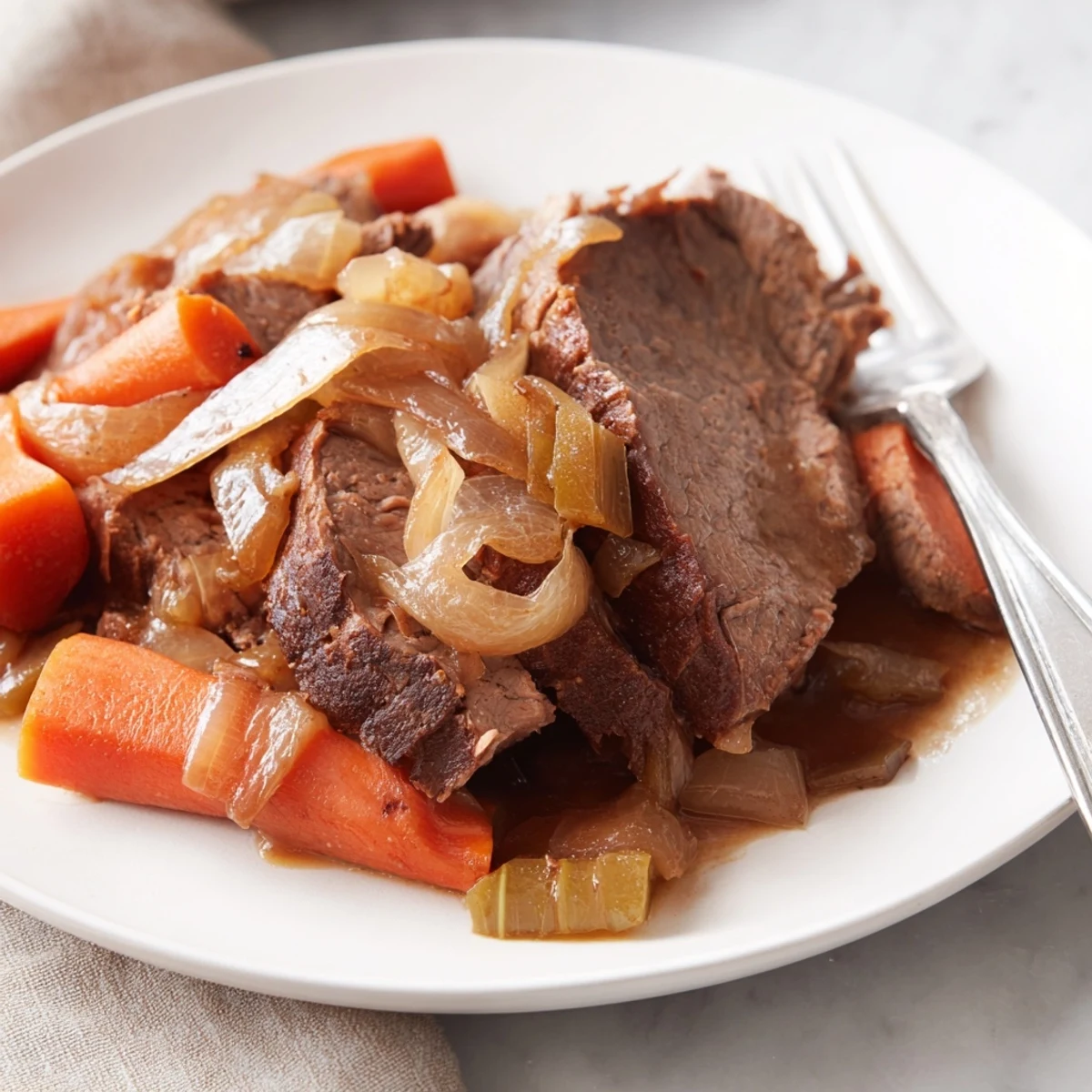 A tender slow cooker pot roast with caramelized onions and vegetables, bathed in rich brown gravy.