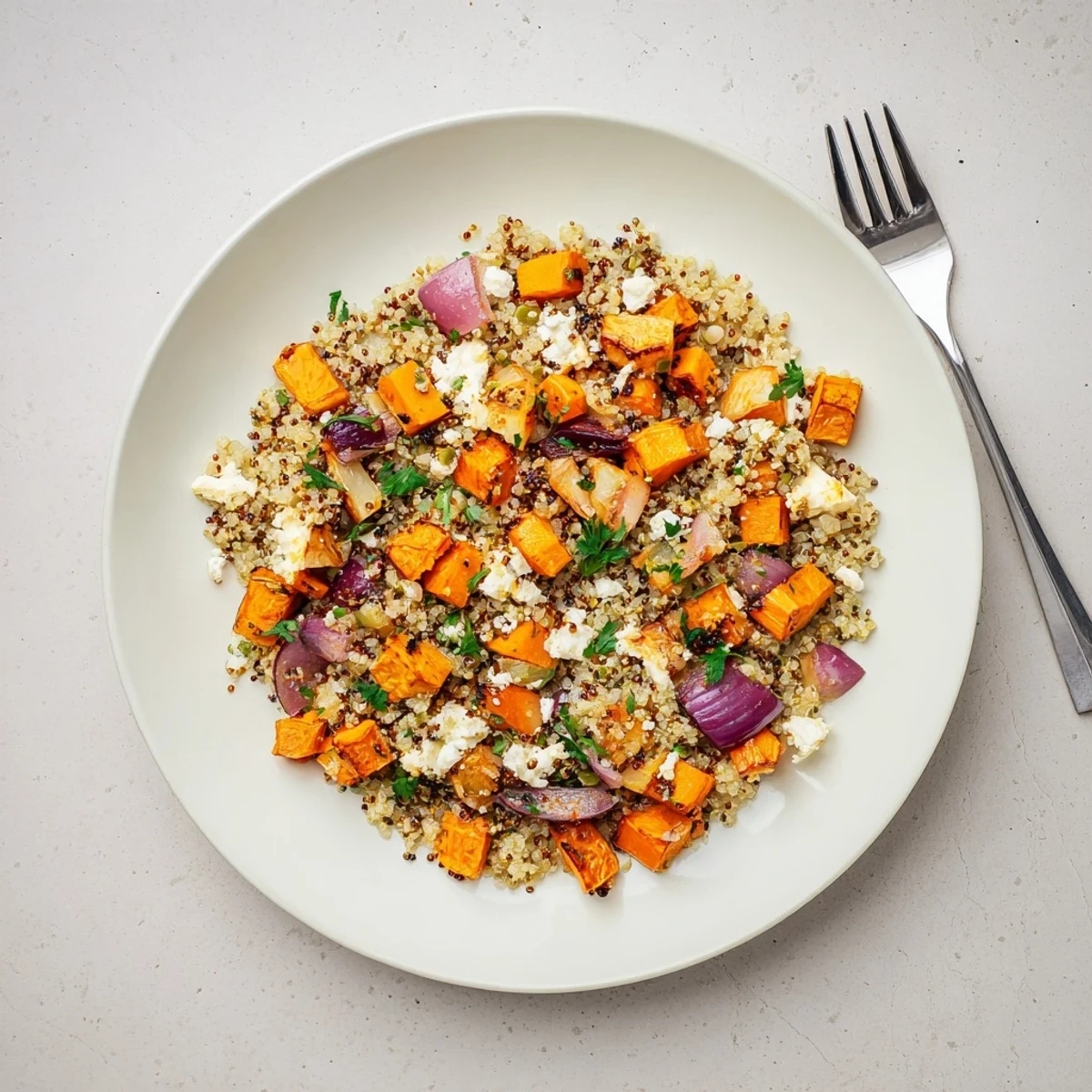 Fluffy quinoa topped with caramelized carrots, parsnips, and sweet potatoes in a warm quinoa salad with roasted root vegetables.  