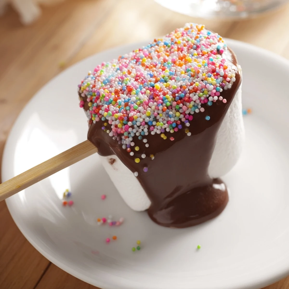 Handheld treats: Dipped Marshmallows with Sprinkles standing upright on a tray, chocolate set, showing the colorful sprinkle finish.