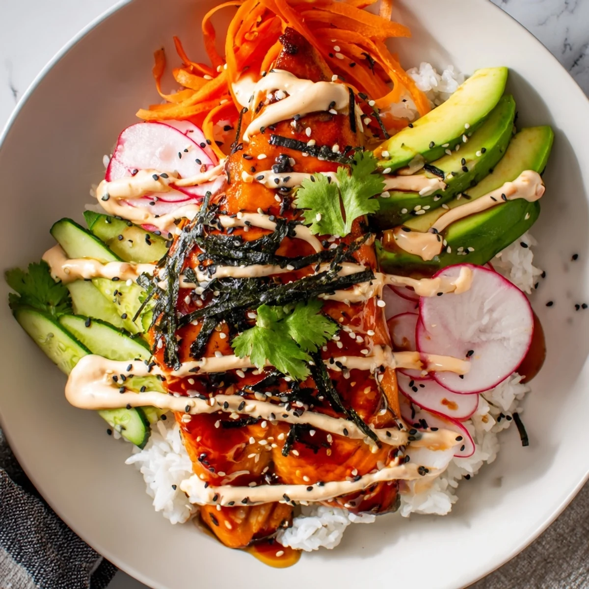 Tender teriyaki glazed salmon rests on fluffy rice with crunchy pickled veggies and sriracha mayo in these bowls.