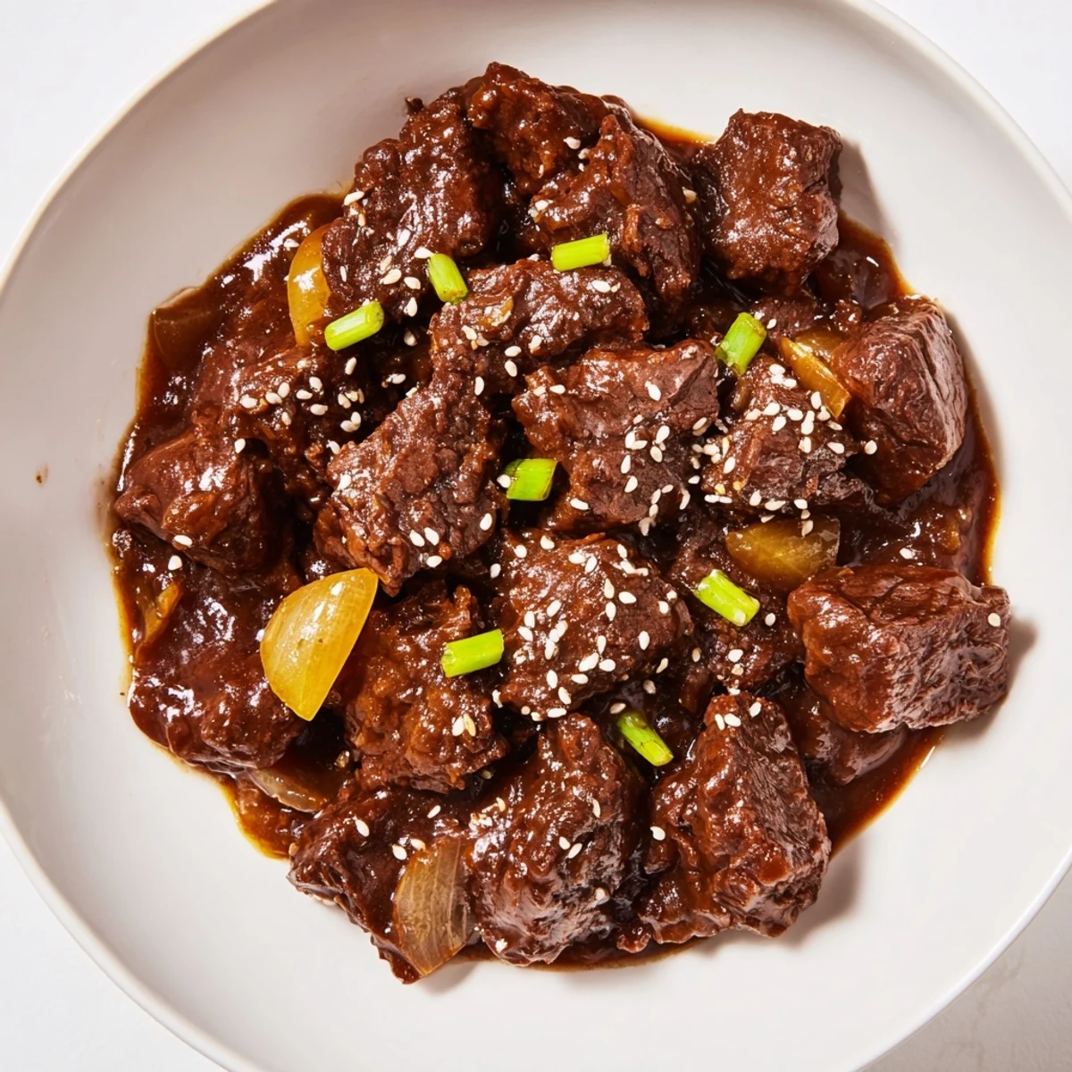 Tender beef cubes coated in glossy sauce fill the slow cooker with rich aromas.