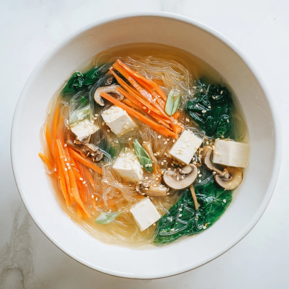 Delicate glass noodles and tofu float in a savory broth for Japanese Harusame Noodle Soup.