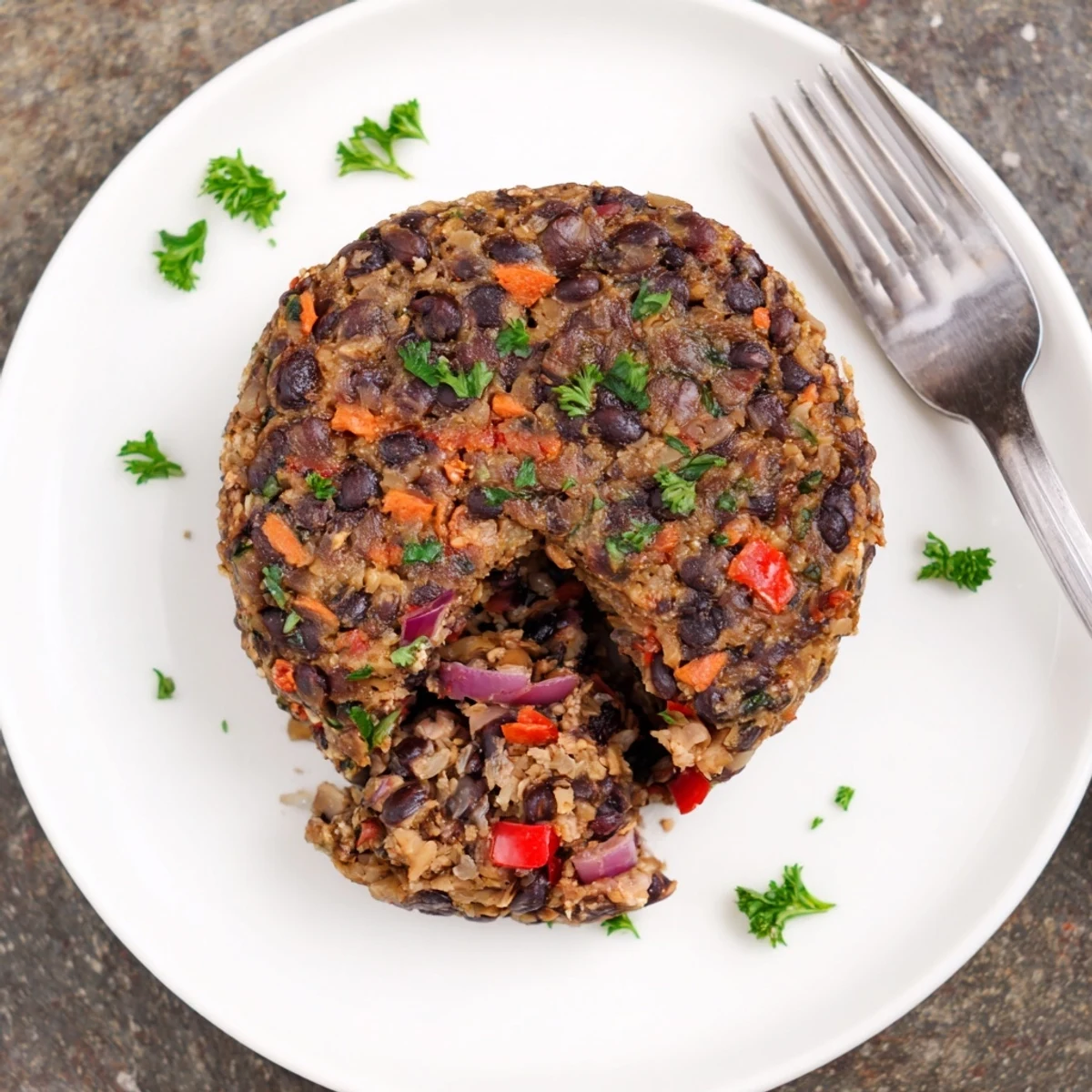 Mushroom Veggie Burgers served on soft buns topped with lettuce, tomato, and pickles beside a fresh green salad.