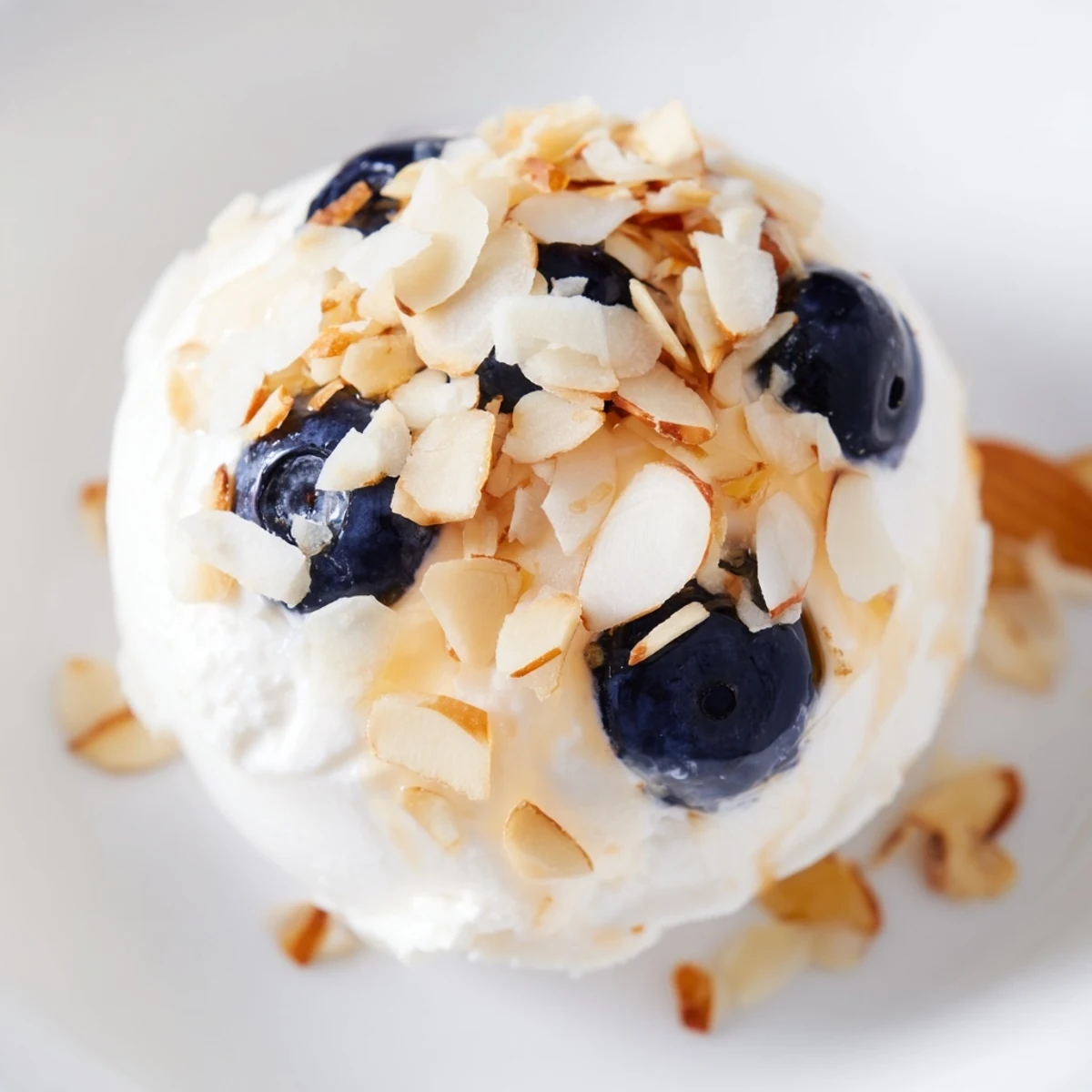 Frozen Blueberry Greek Yogurt Bites sprinkled with shredded coconut and nuts, perfect for a healthy snack.