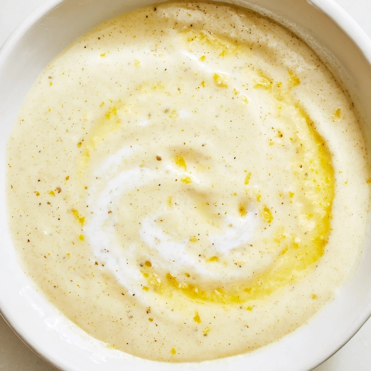 Thick tangy lemon dressing spooned onto crisp lettuce with olive oil shine