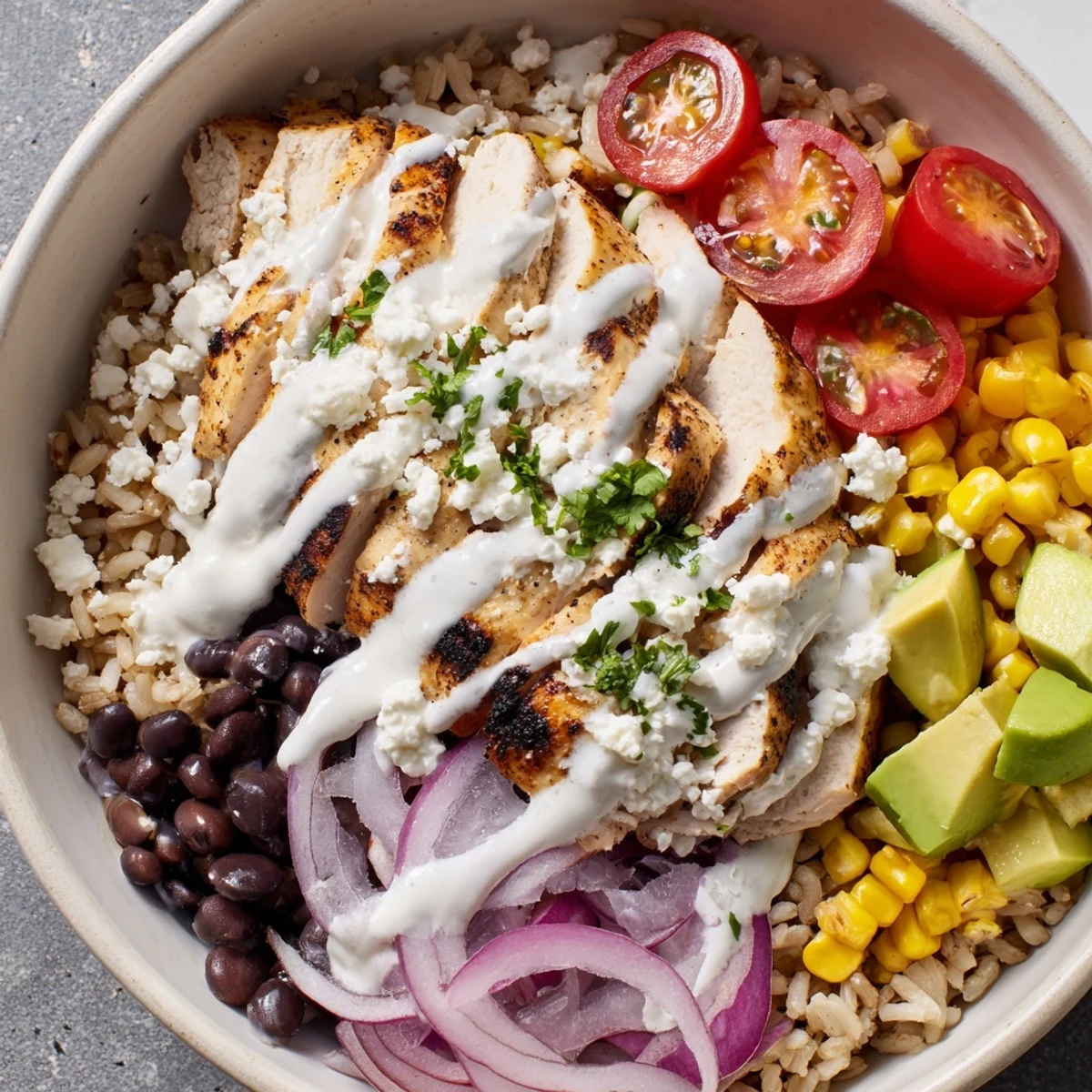 Hearty protein packed street corn chicken bowl featuring spiced chicken, sweet corn, black beans, and fresh toppings