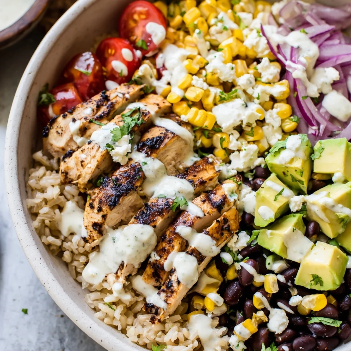 Vibrant protein packed street corn chicken bowl layered with juicy chicken, corn, tomatoes, and tangy yogurt dressing