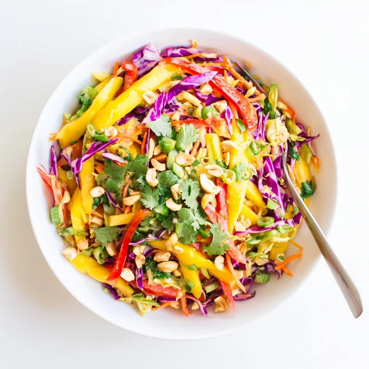 Fresh mango slaw with crisp red cabbage and carrots in a tangy lime dressing