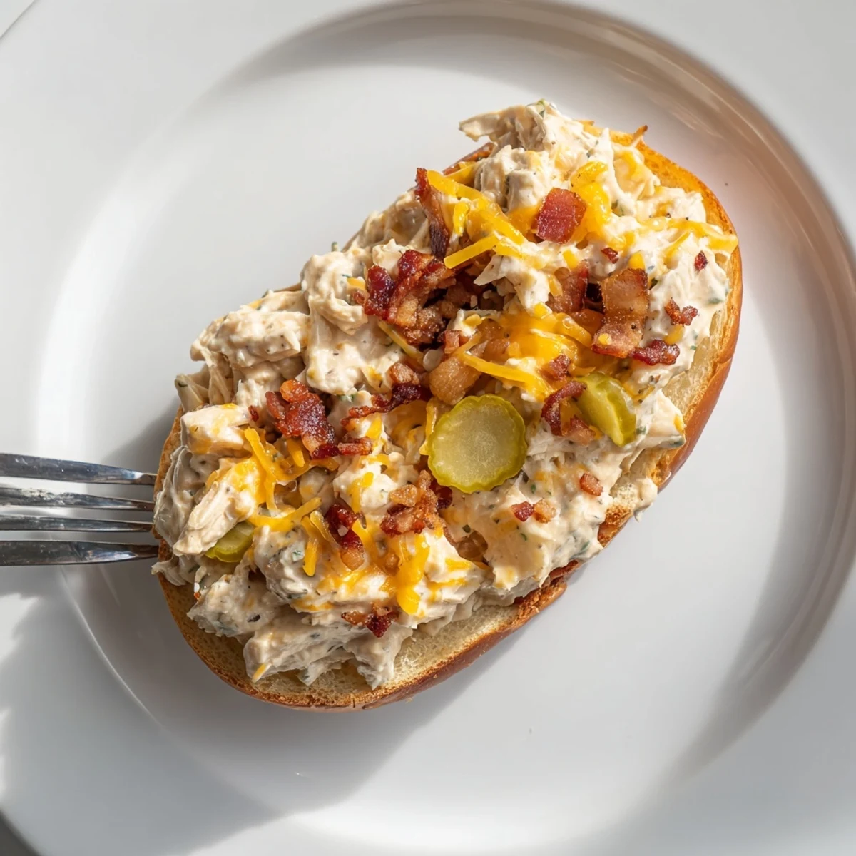 Warm Crack Chicken Sandwiches piled with bubbly cheesy filling and crispy bacon