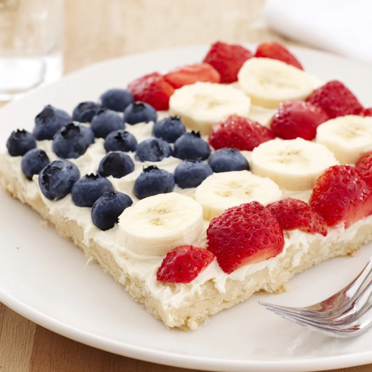 American Flag Fruit Pizza on baking sheet, glossy berries and creamy frosting