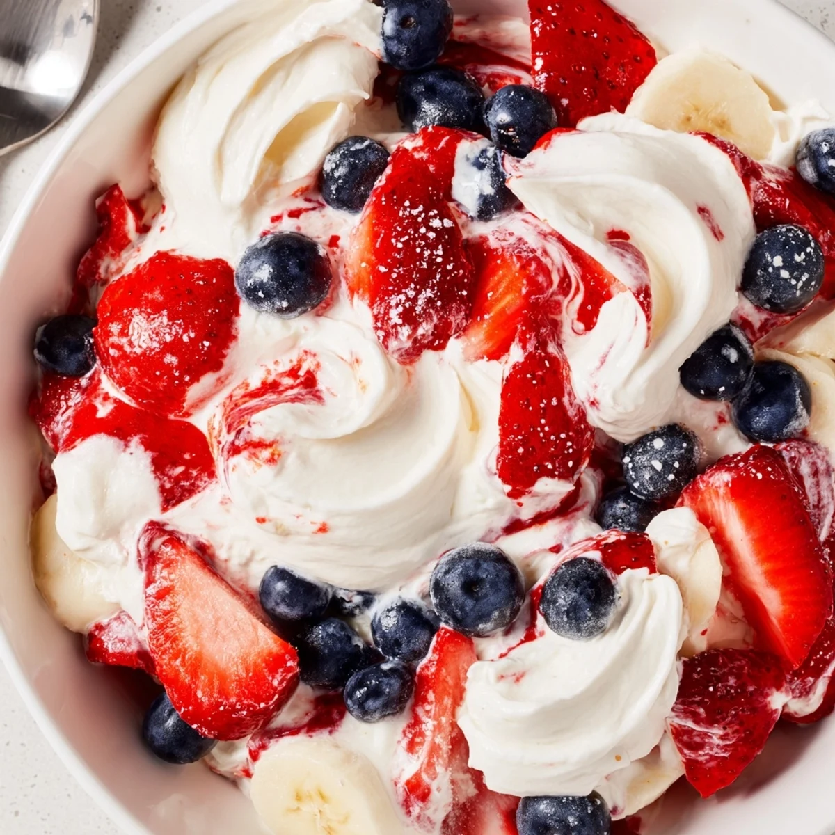 Easy Red White And Blue Cheesecake Salad for picnics, creamy texture, festive garnish