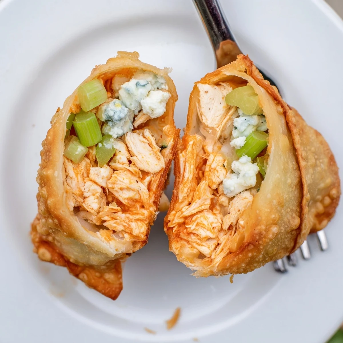 Crispy Buffalo Chicken Egg Rolls, golden fried, spicy cheesy filling with ranch