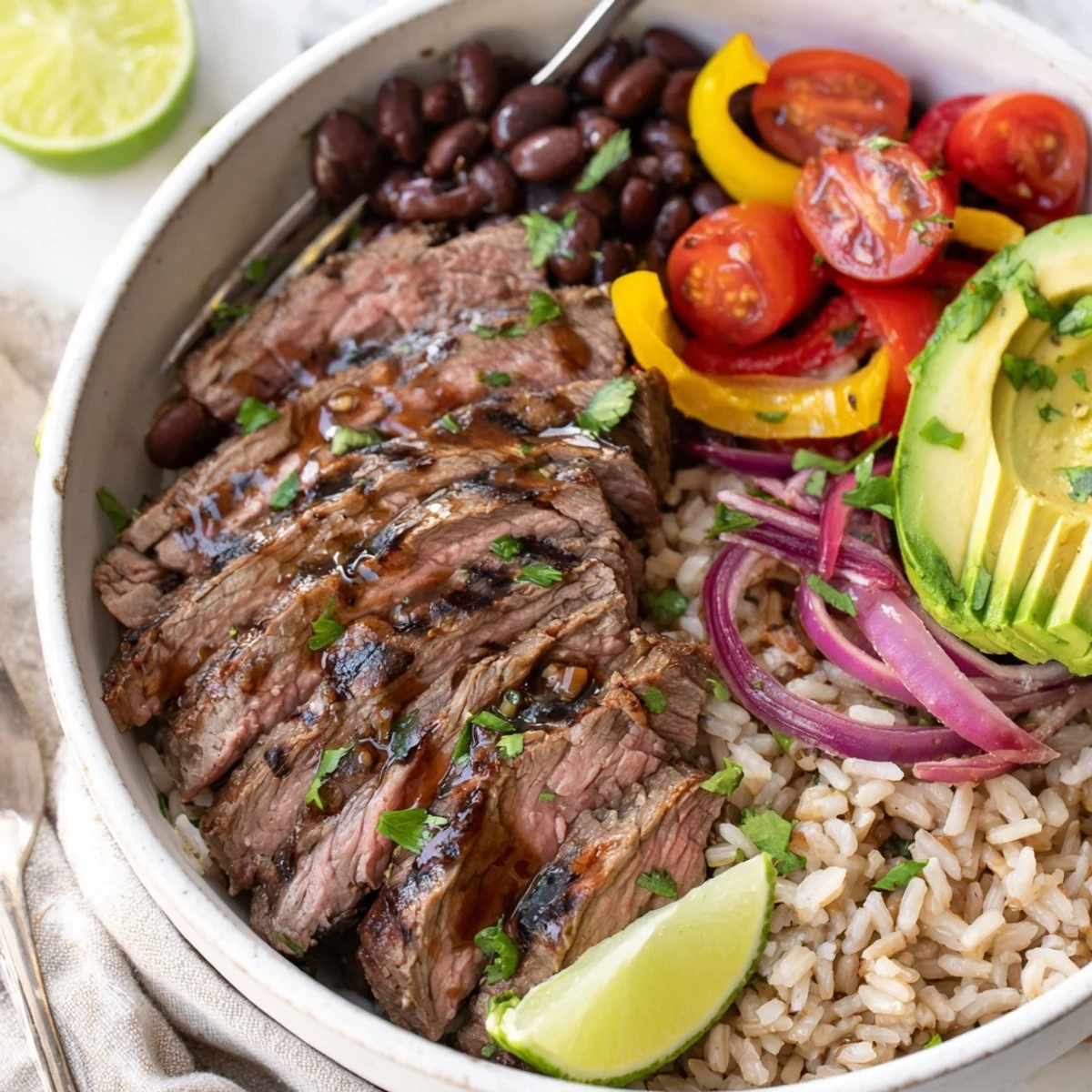 Steak Fajita Power Bowls with sizzling marinated steak, vibrant peppers and lime.