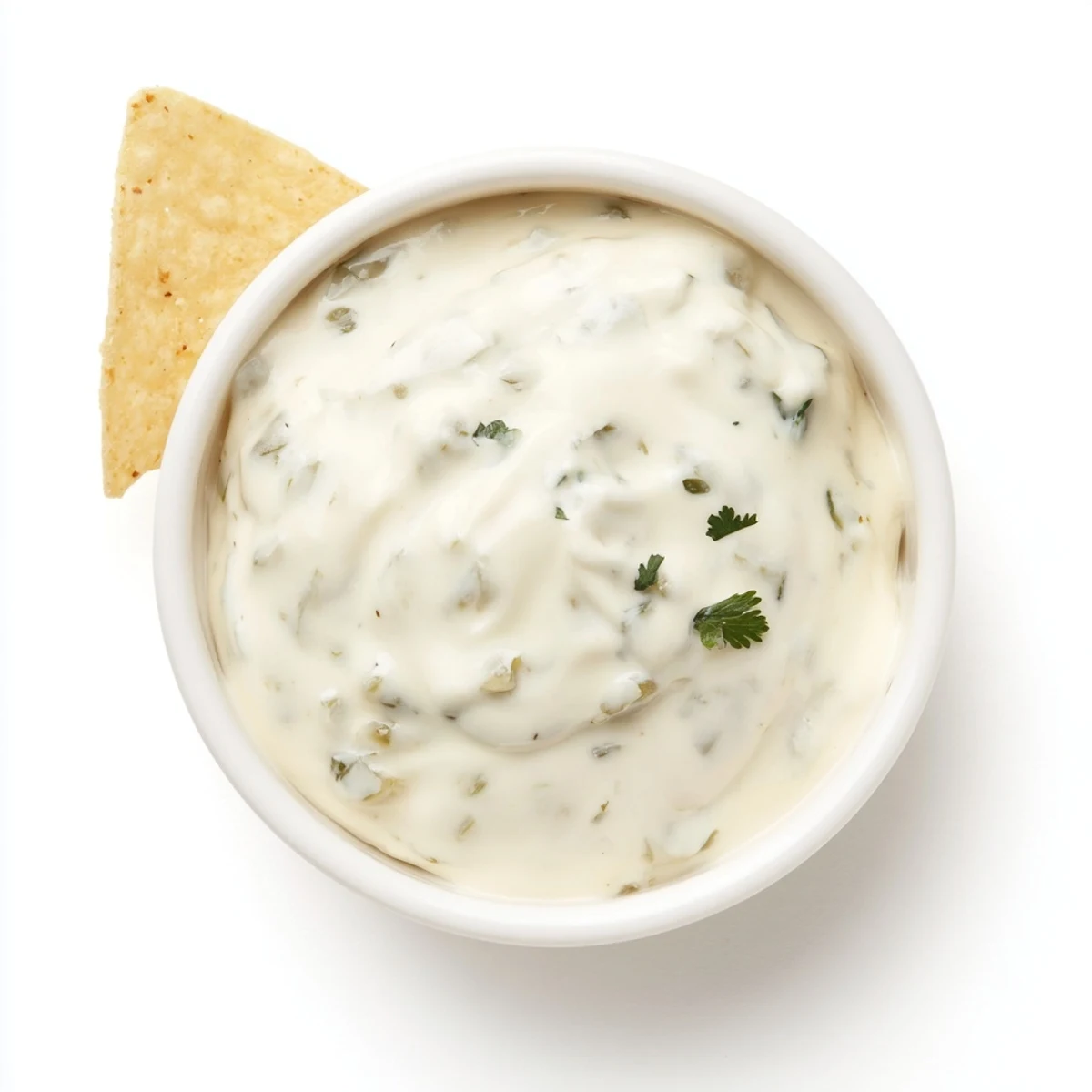 Bowl of tangy Mexican white sauce ready for dipping tortilla chips and vegetables