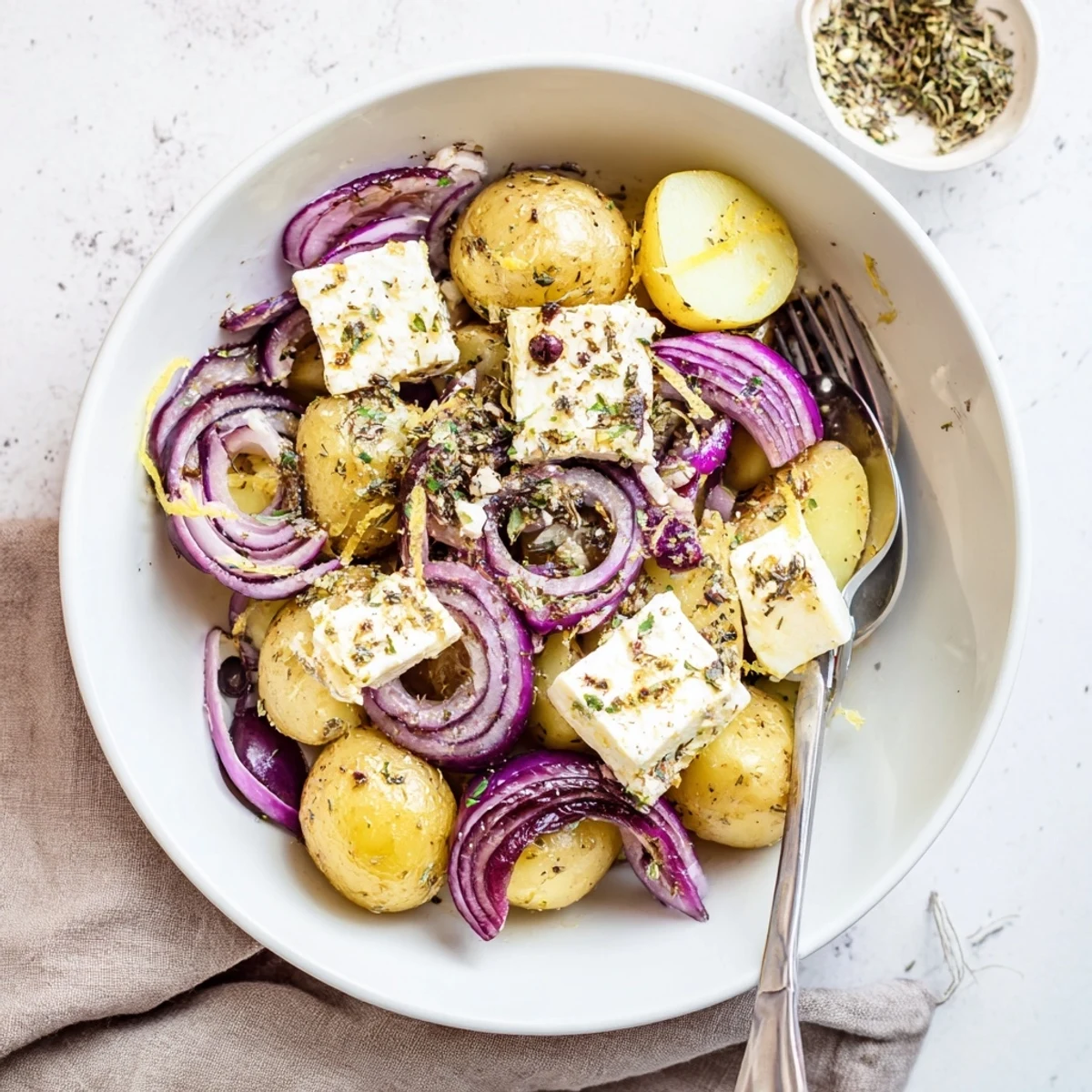 Warm Baked Feta Potatoes served hot with lemon zest and crusty bread