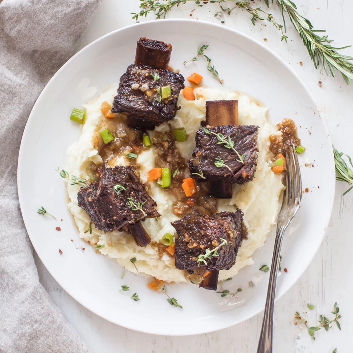 Slow Cooker Short Ribs braised to tender, fall-off-the-bone perfection over mashed potatoes