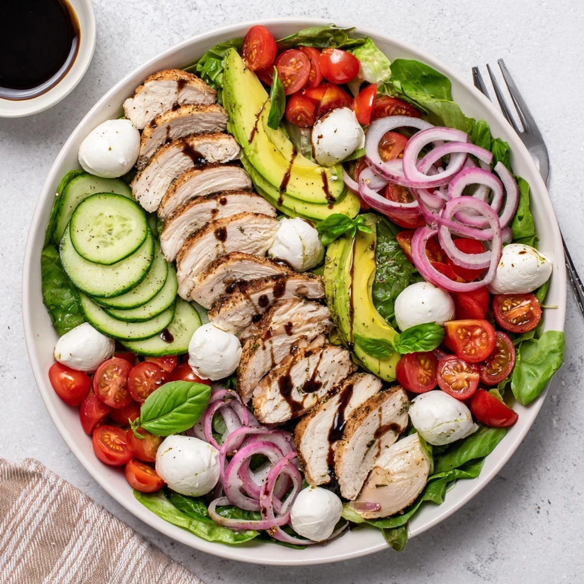 Baked Marinated Chicken Salad With Mozzarella And Balsamic Vinaigrette, served on crisp mixed greens