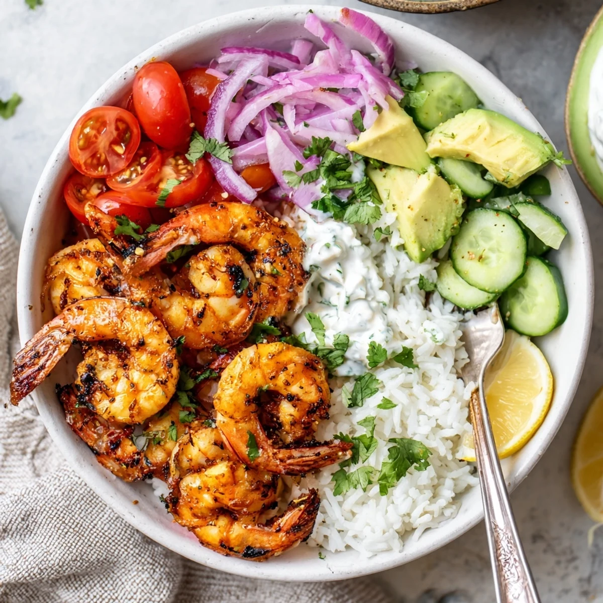 Warm Garlic Shrimp Bowl served with lemon wedge and creamy yogurt sauce