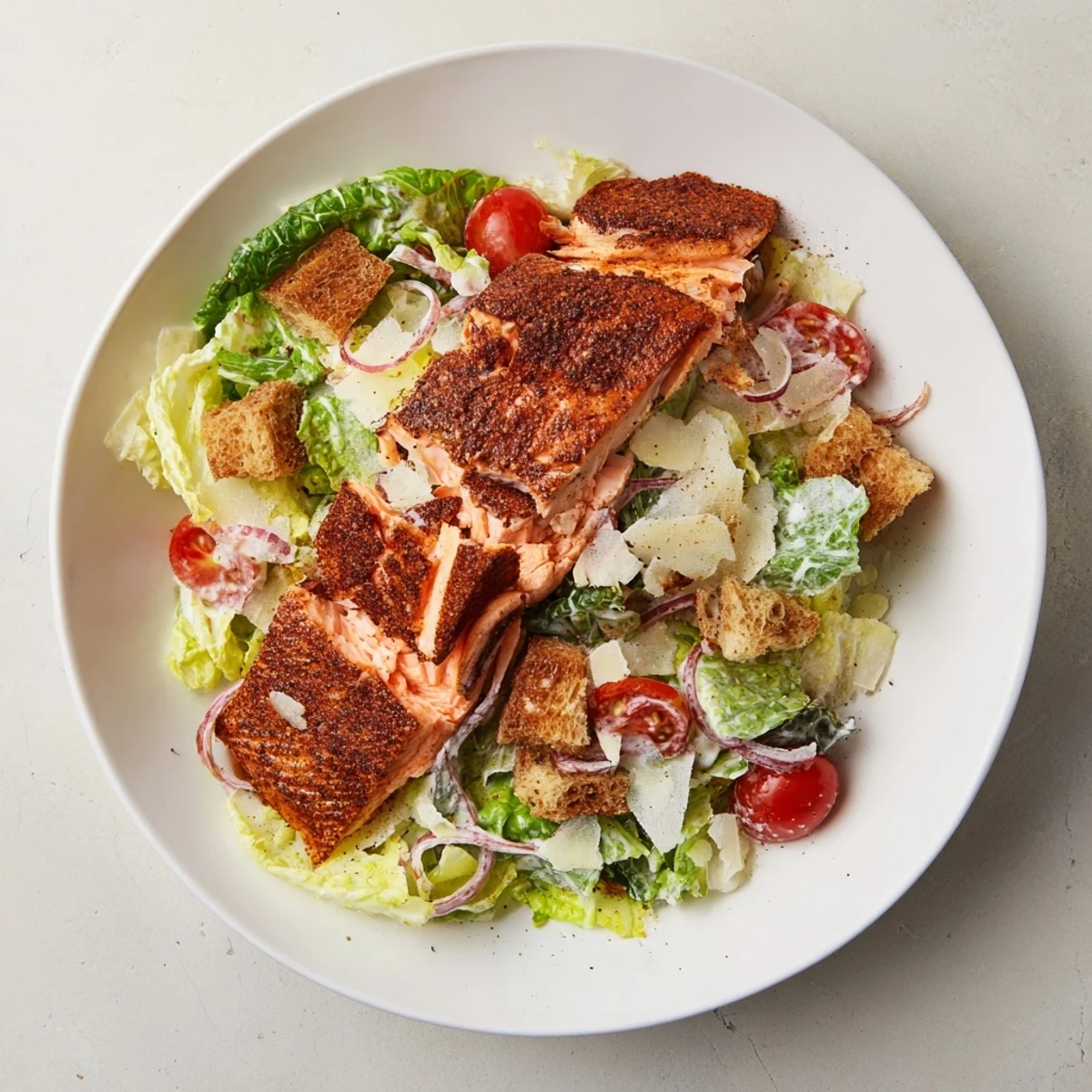 Fork-tender flakes in a Smoky Salmon Caesar Salad drizzled with zesty dressing