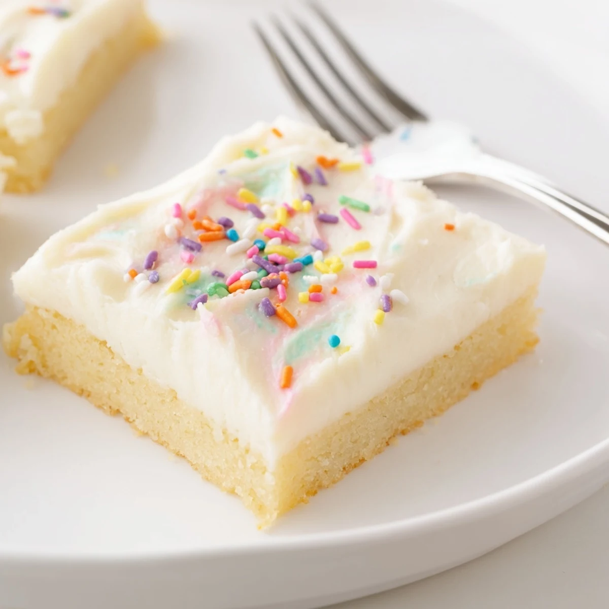 Frosted Sugar Cookie Bars Recipe showing soft buttery bars topped with colorful sprinkles