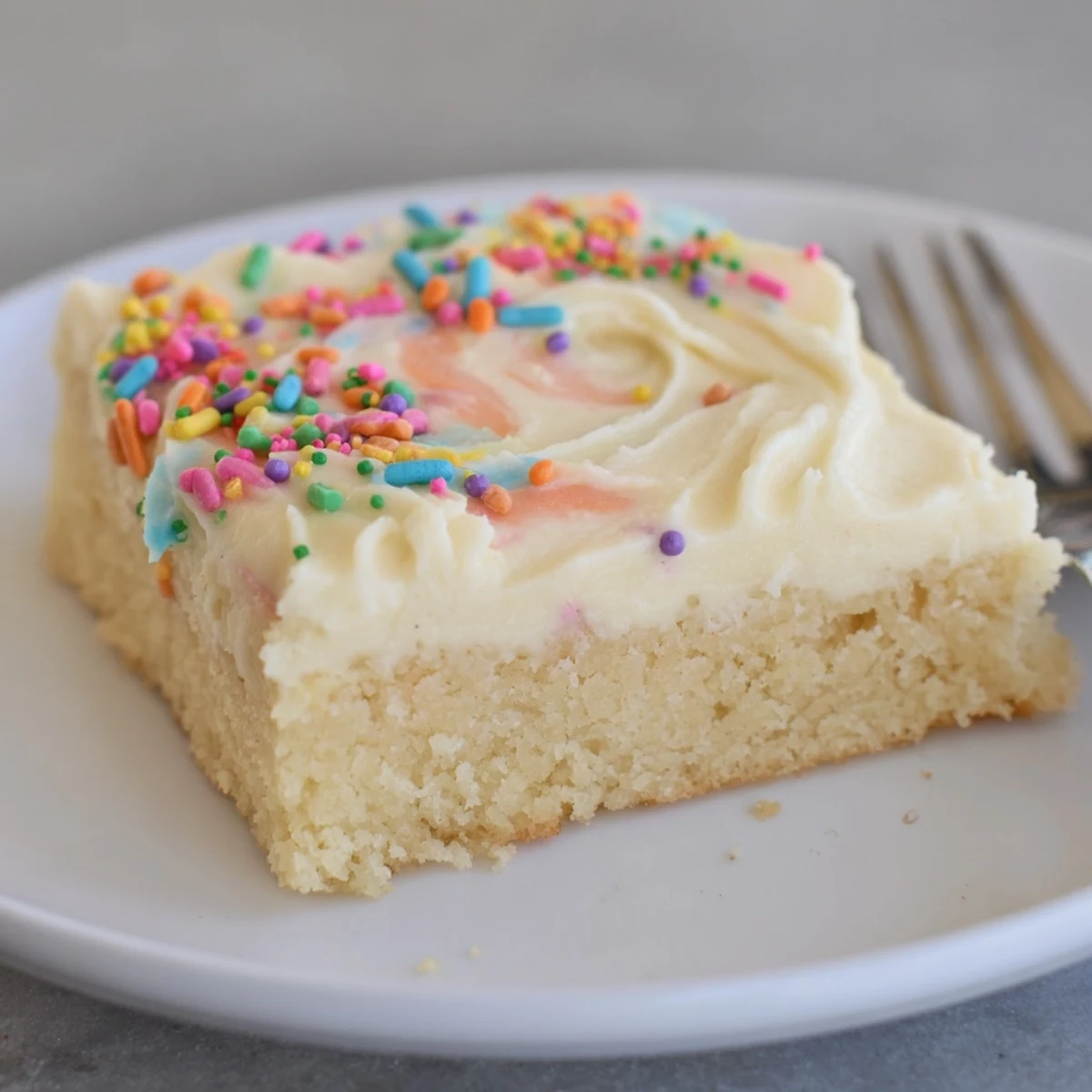 Warm Frosted Sugar Cookie Bars Recipe cooling on wire rack, frosting glossy