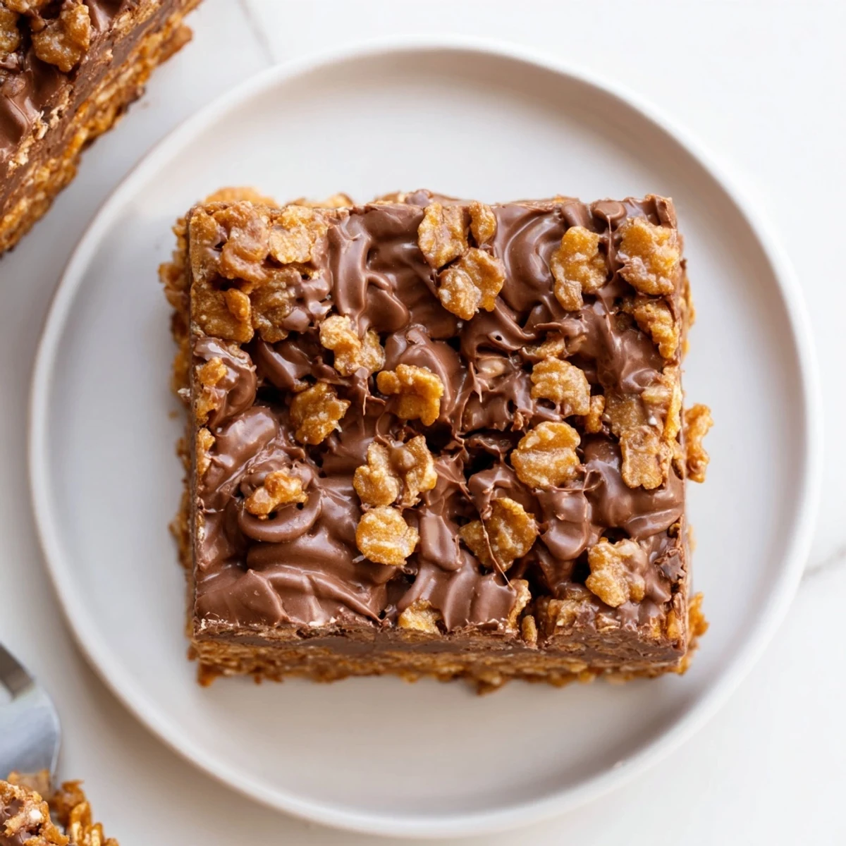 Cornflake Chocolate Fudge Bars glistening with glossy fudge, crunchy cornflake texture.