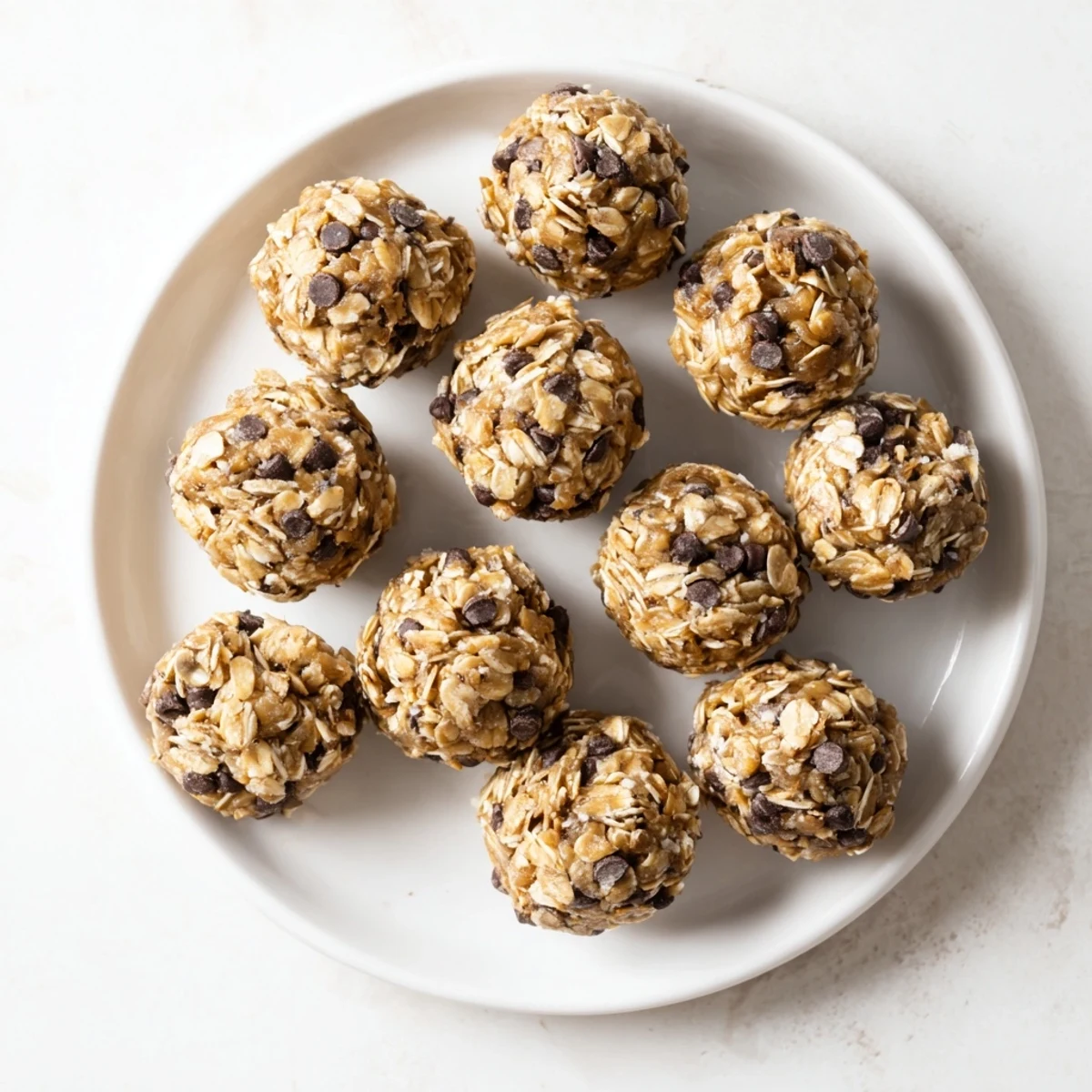 Soft peanut butter no bake energy balls topped with coconut flakes ready for snacking