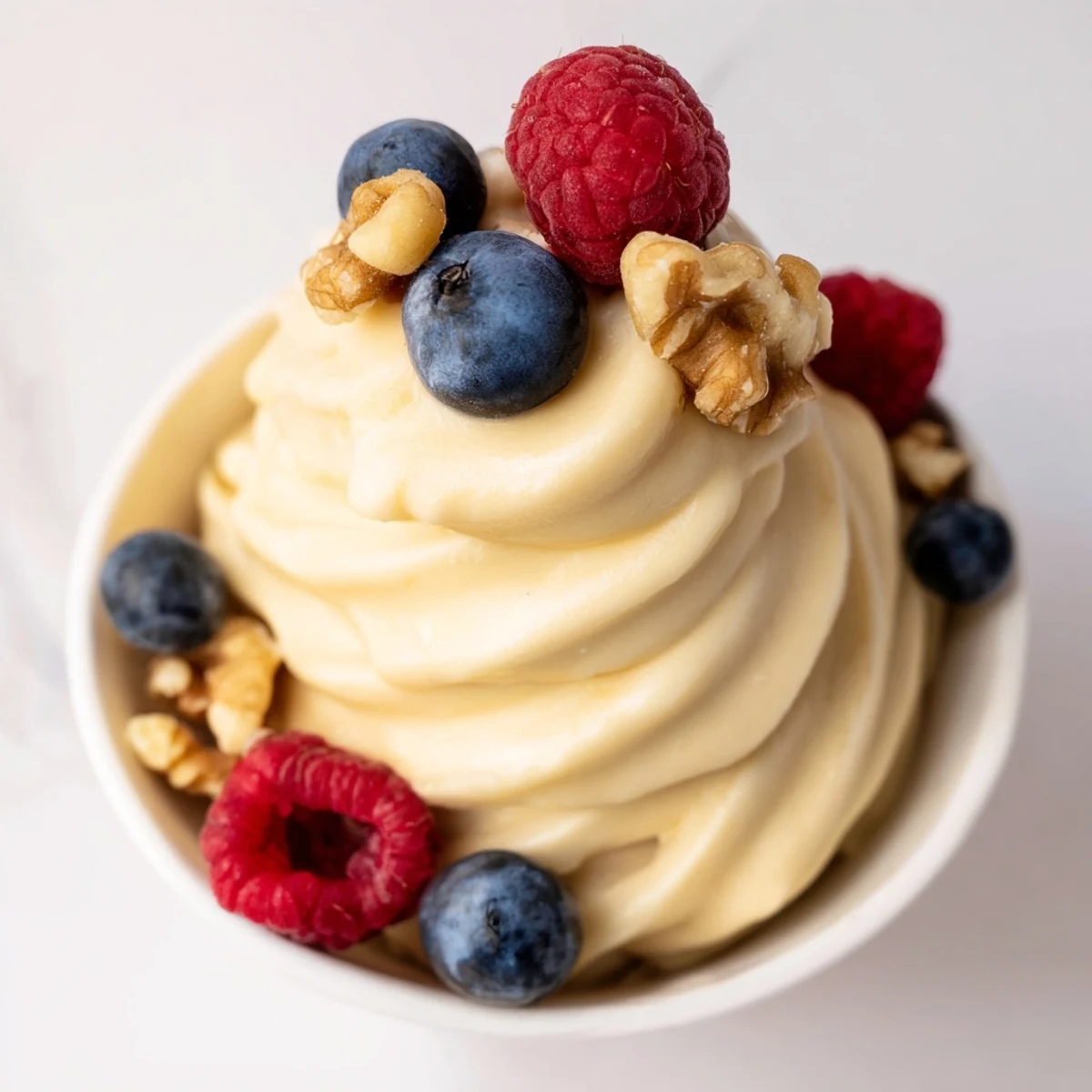 Dairy-free banana nice cream recipe served in glass bowls with sliced banana garnish