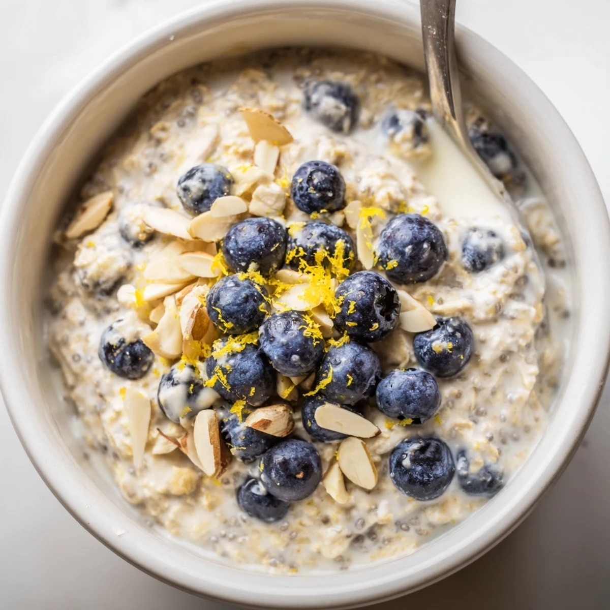 Make ahead Blueberry Lemon Overnight Oats swirled with yogurt and juicy berries