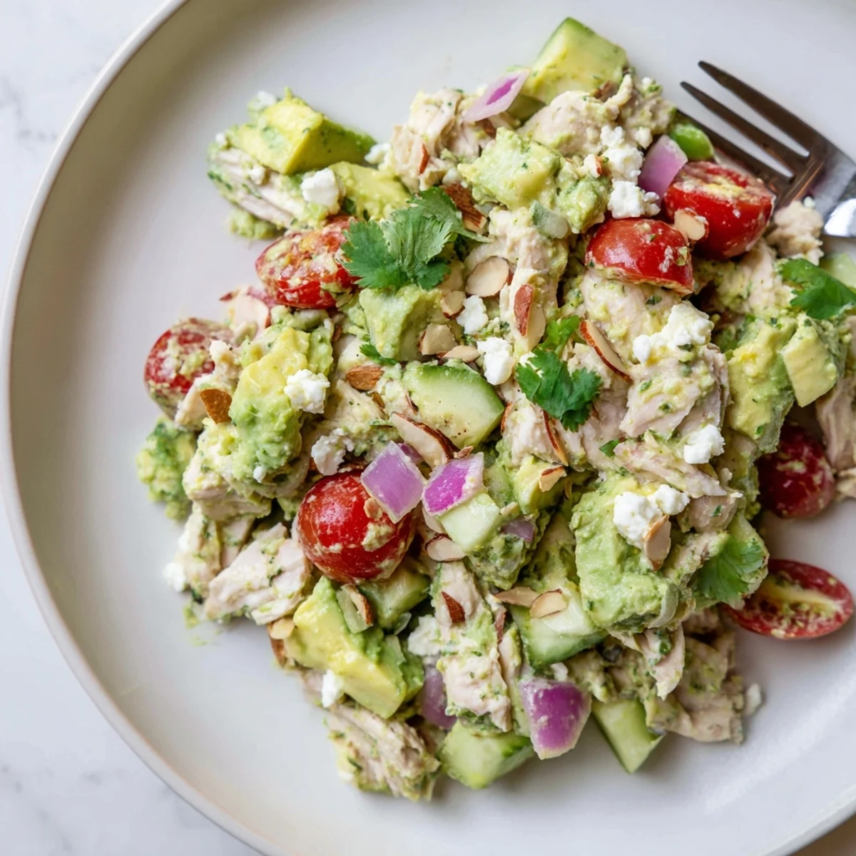 Creamy Avocado Chicken Salad with shredded breast meat, diced avocado, lime dressing.