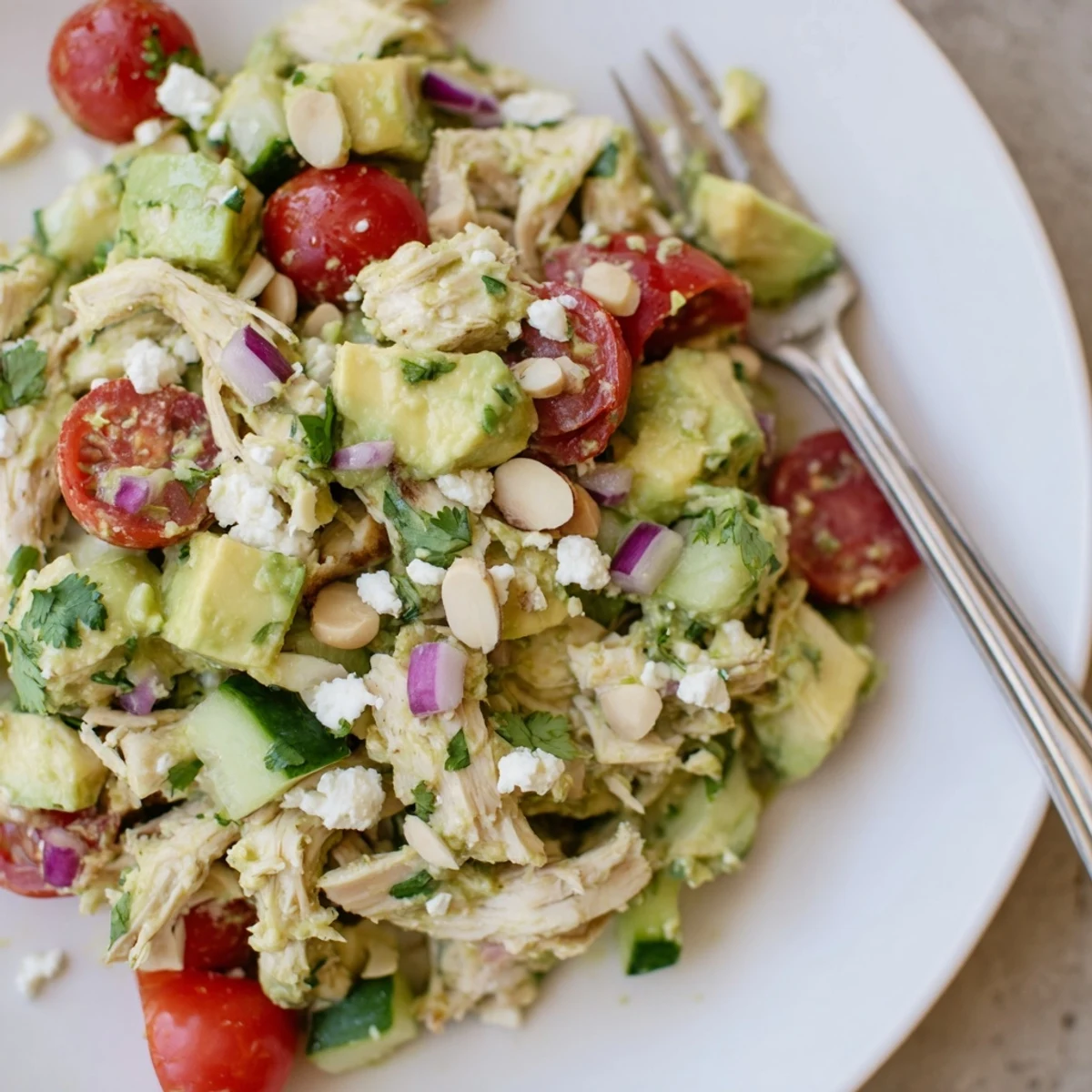 Avocado Chicken Salad tossed with crisp cucumber, cherry tomatoes, and fresh cilantro.