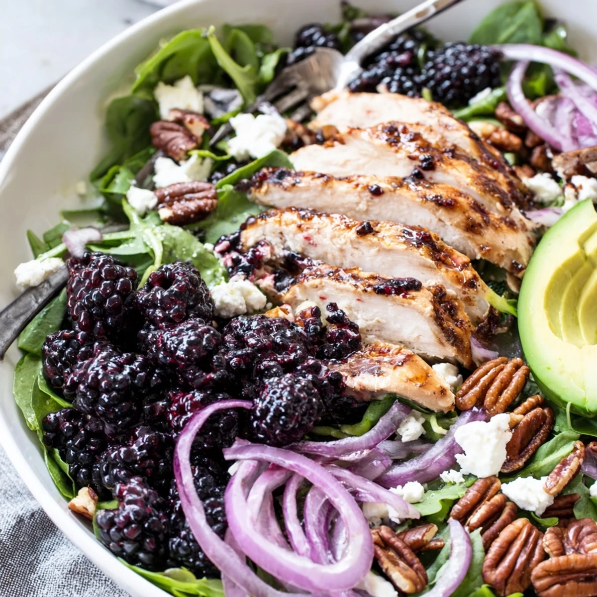Bright Sweet Tangy Blackberry Chicken Salad topped with crumbled goat cheese and pecans.