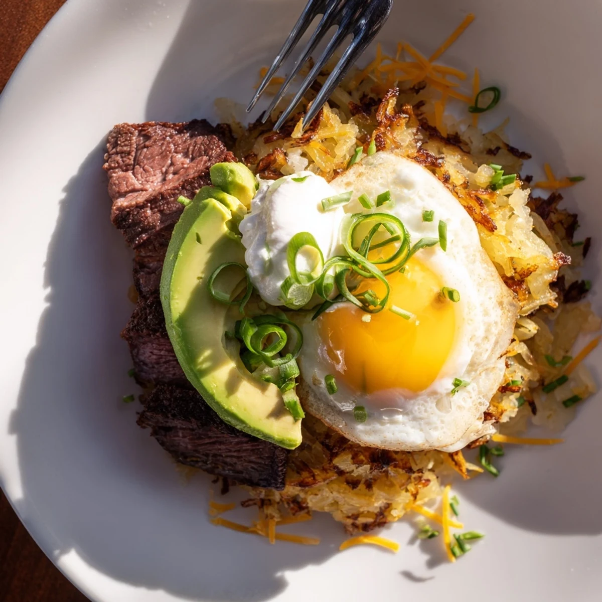 Loaded Steak Egg Hash Brown Stacks Recipe with crispy golden hash and runny egg
