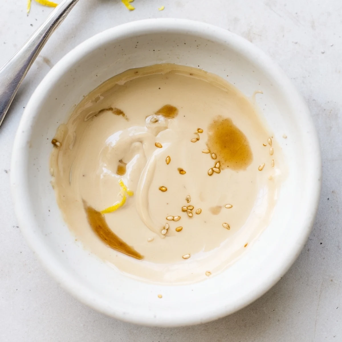 Creamy Sesame Dressing drizzled over mixed greens, nutty aroma and silky texture