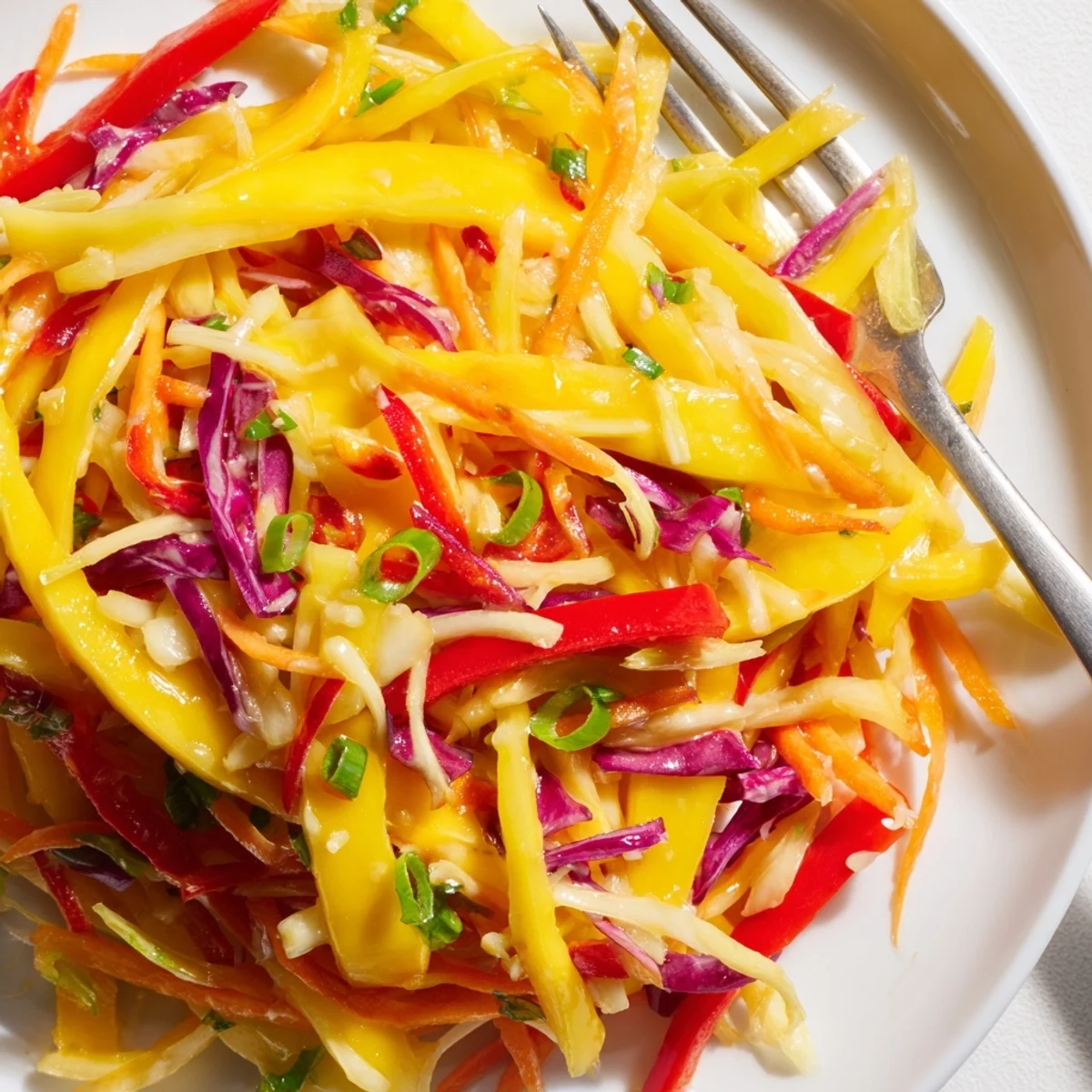 Bright Mango Slaw Recipe tossed with cilantro, toasted cashews, perfect picnic side.