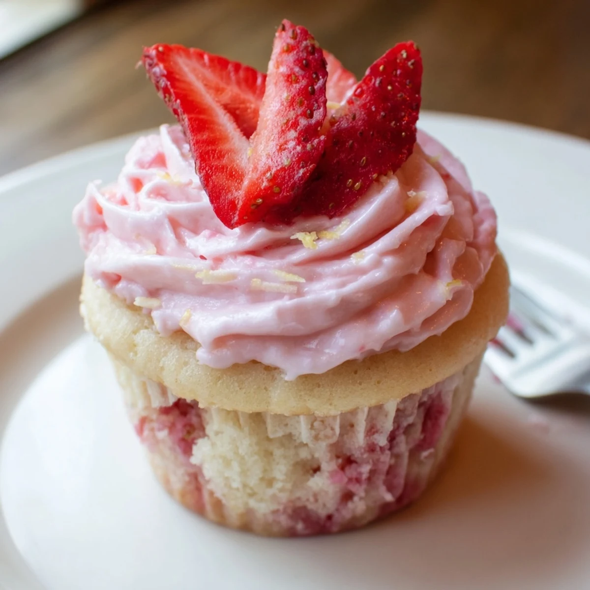 Strawberry Lemonade Cupcakes topped with zesty buttercream and sugared strawberry slices