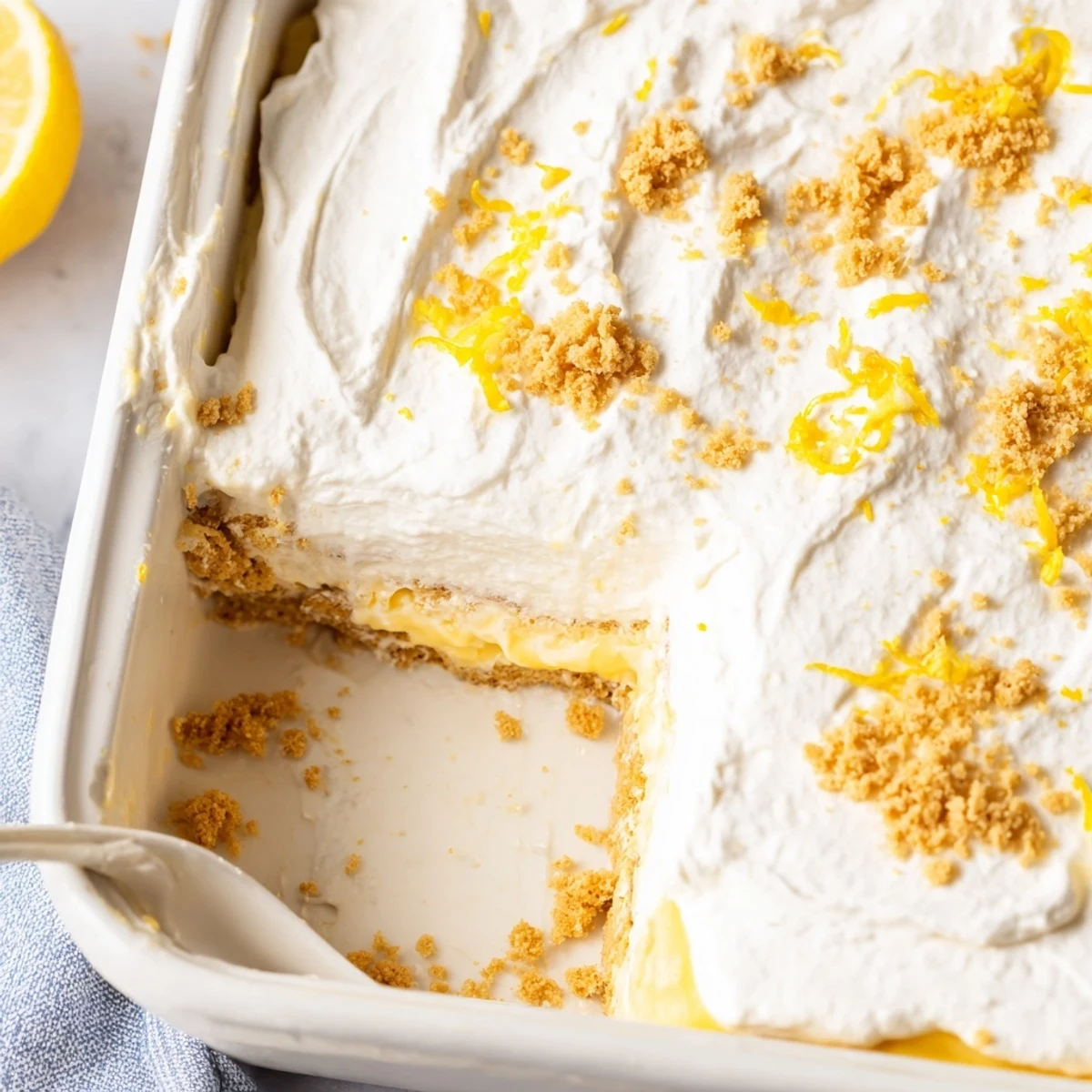 Chilled Lemon Lush Cake on a plate, crisp crust and zesty lemon