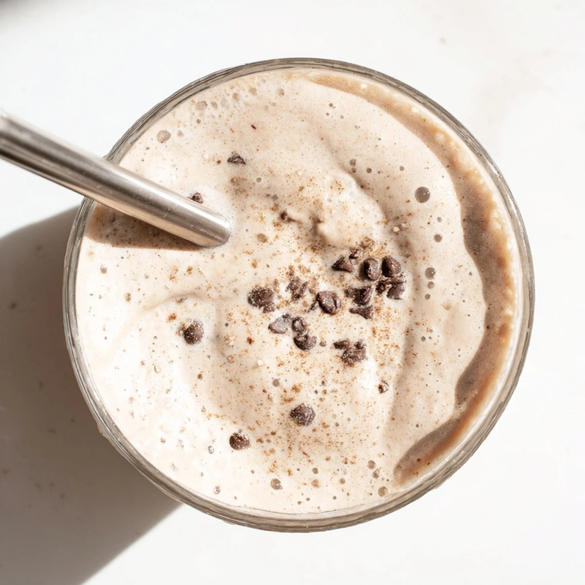 Frosty oatmeal cookie dough protein smoothie blended rich and speckled with chocolate chip bits
