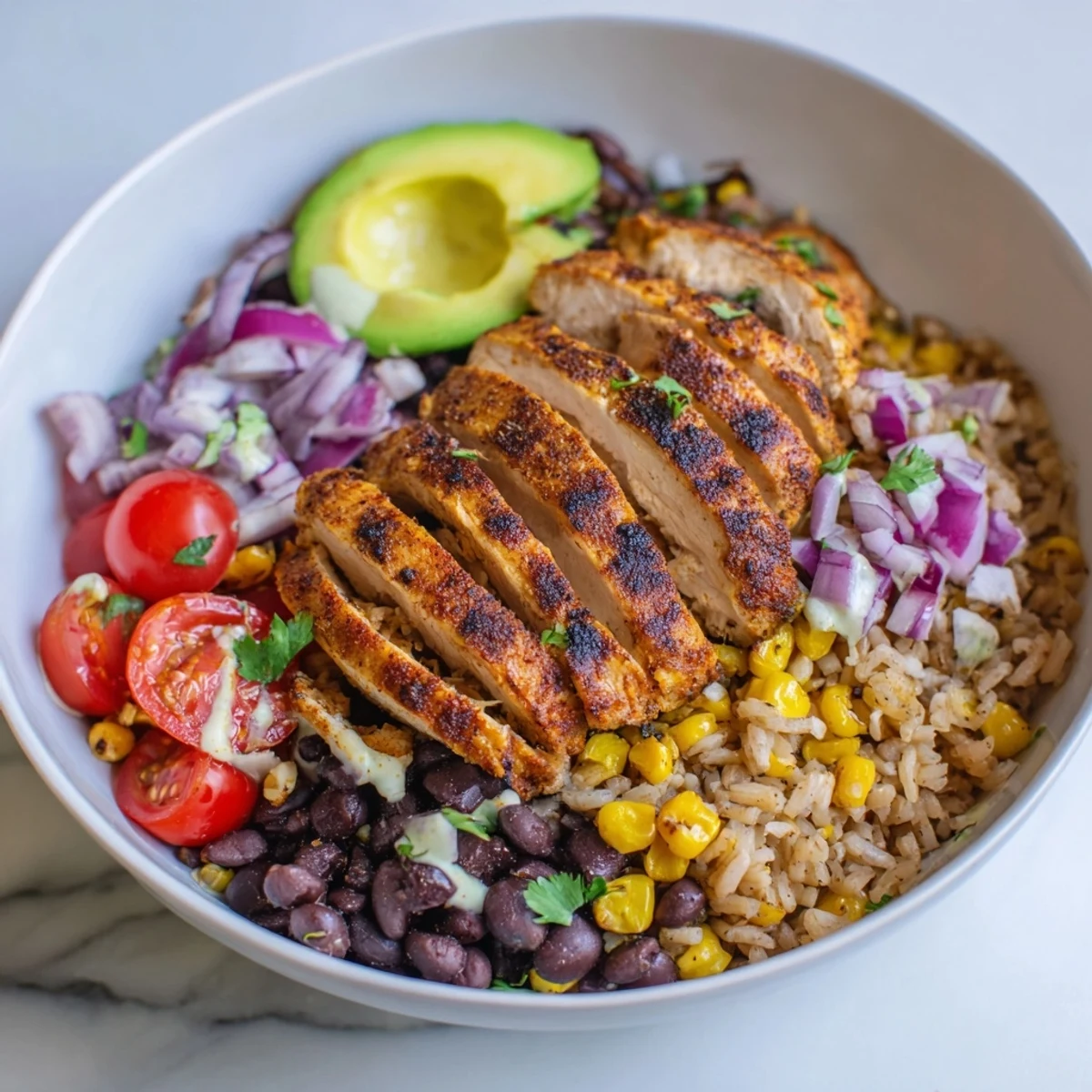 Grilled sliced chicken served over quinoa with charred street corn and colorful vegetables