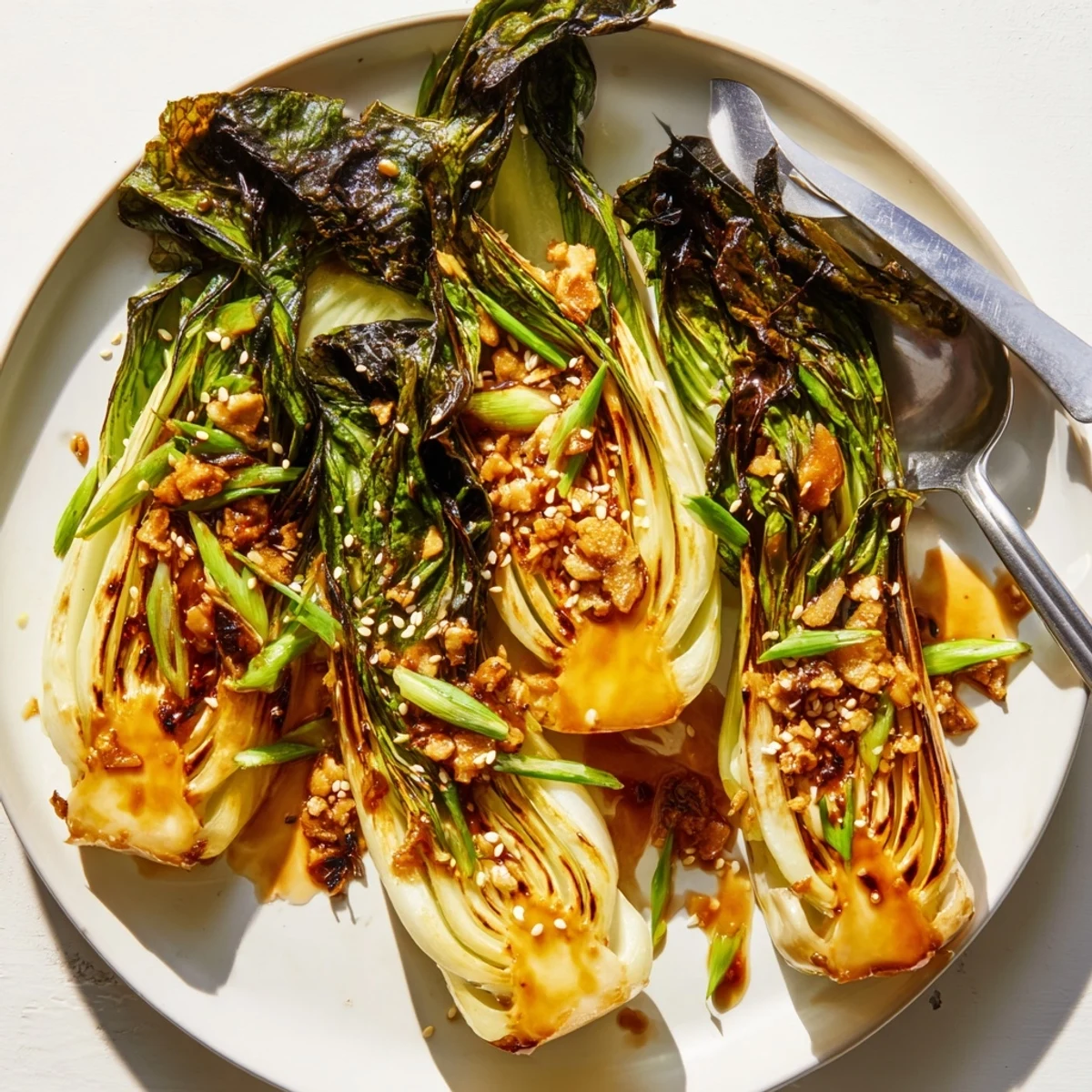 Golden caramelized garlic coats tender bok choy in a glossy, savory-sweet skillet side dish.