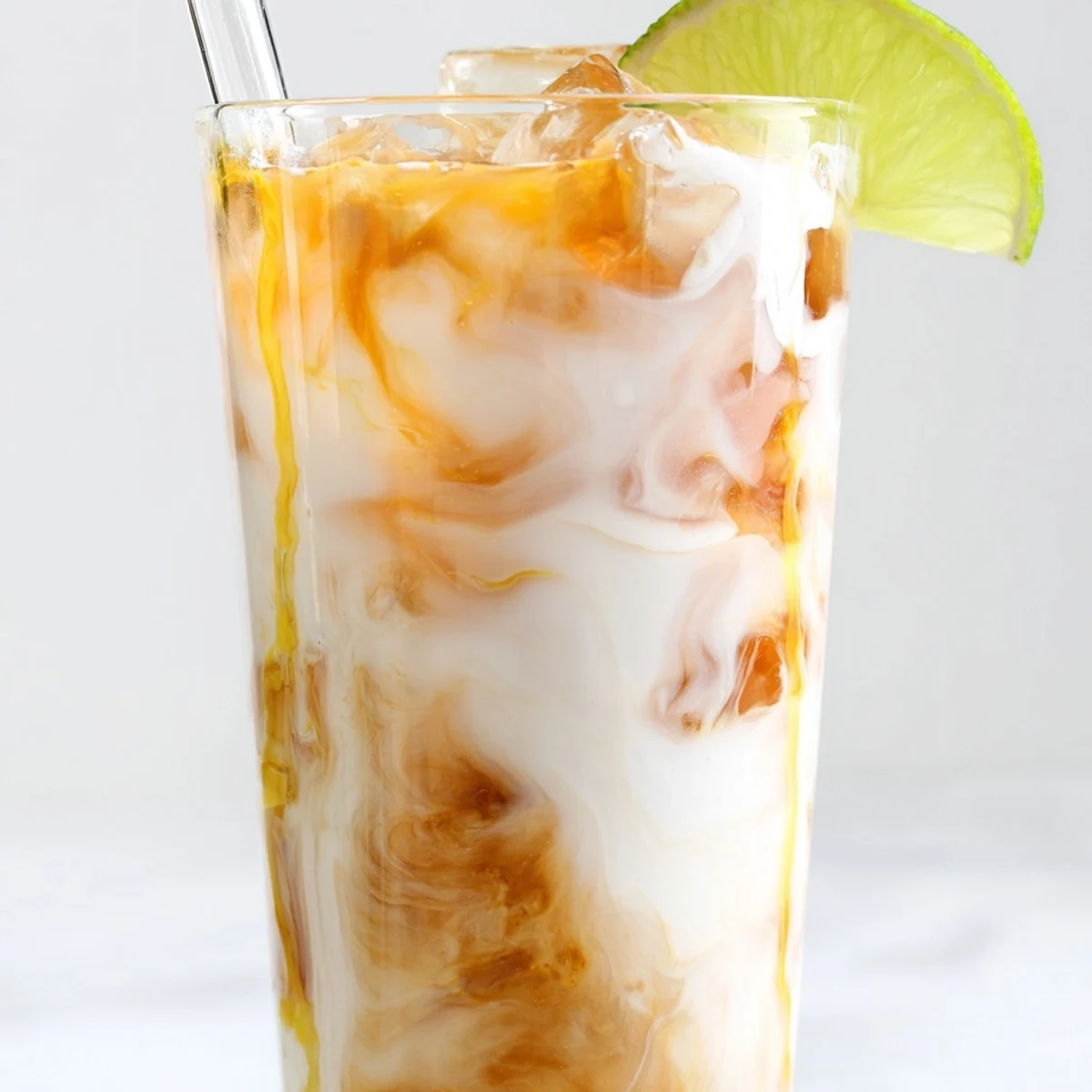 Creamy marbled Tropical Thunder Dirty Soda served over ice with pineapple wedges on top