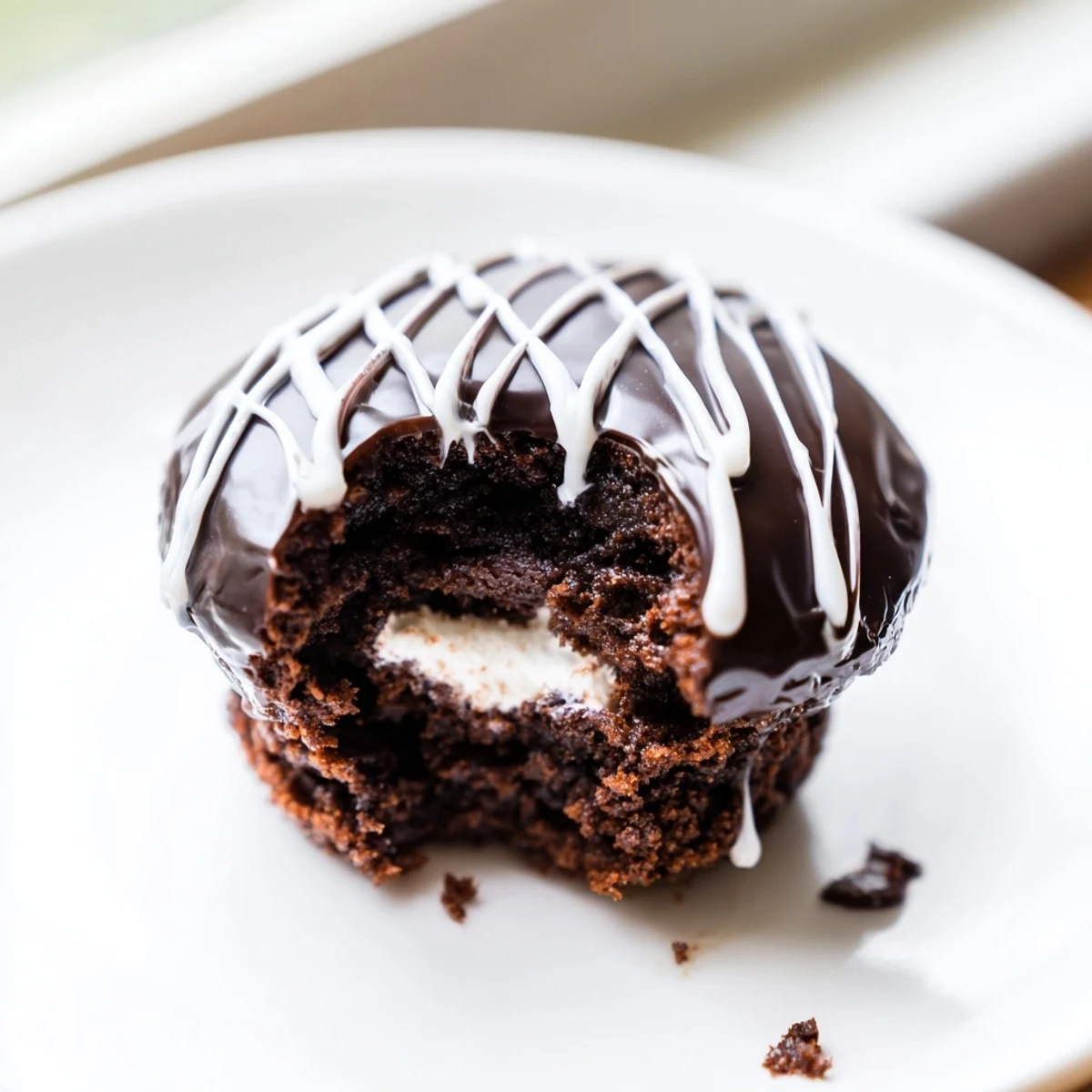 Homemade Hostess Cupcakes sliced open revealing fluffy marshmallow filling inside