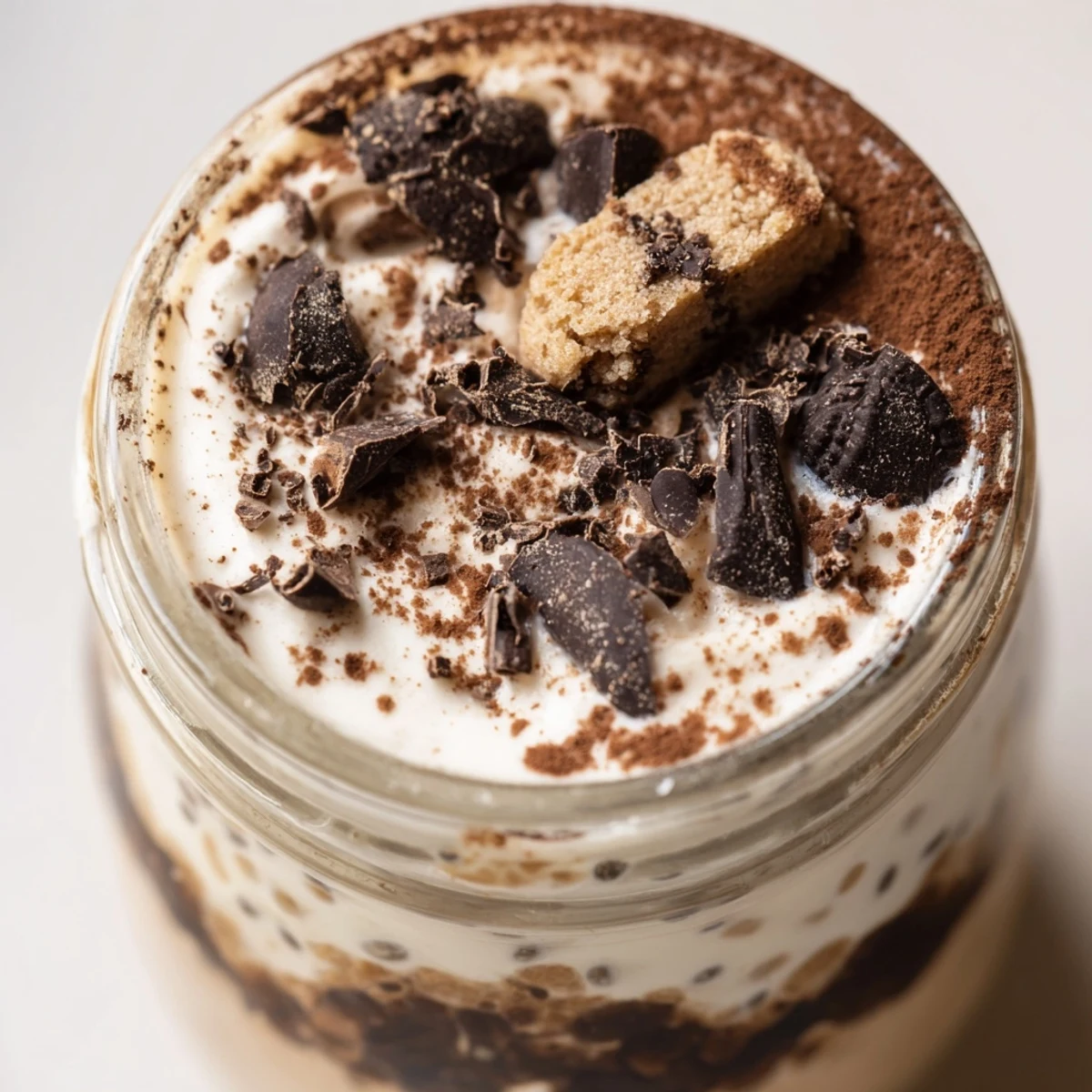 Creamy tiramisu overnight oats layered with mascarpone and dusted with cocoa powder