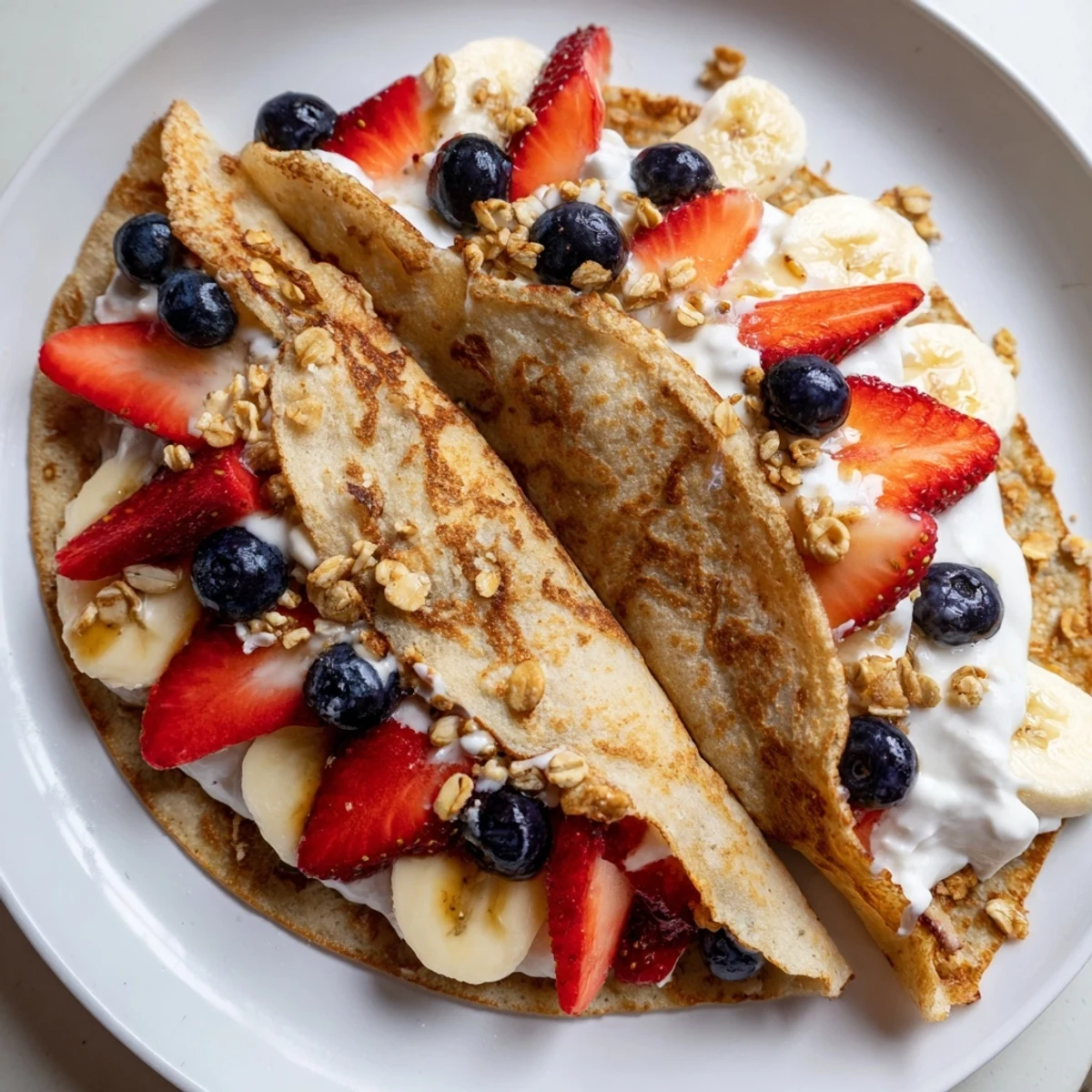 Fluffy pancake tacos folded and stuffed with sweet berries and creamy yogurt
