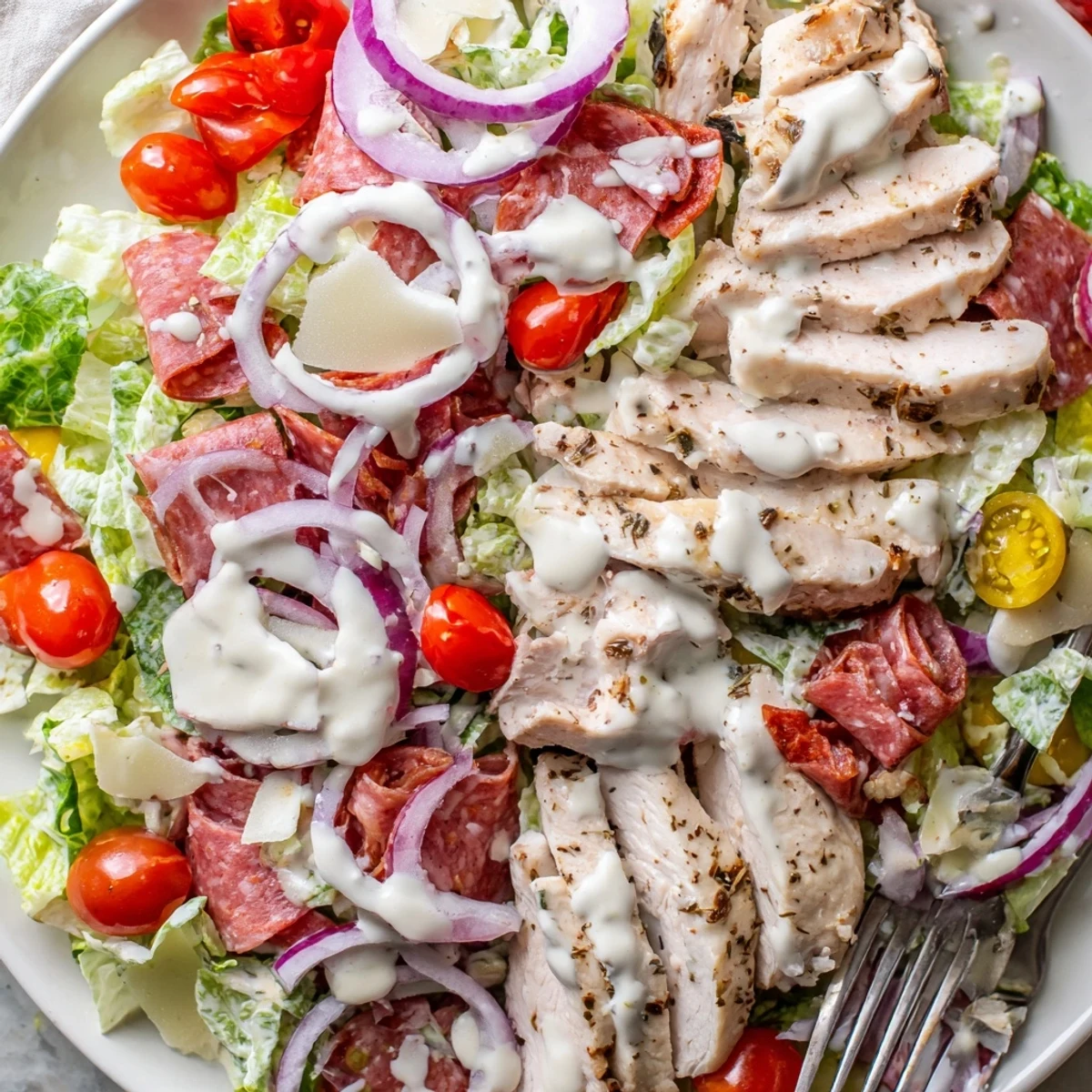 Italian Grinder Chicken Salad topped with sliced deli meats and tangy vinaigrette on crisp romaine