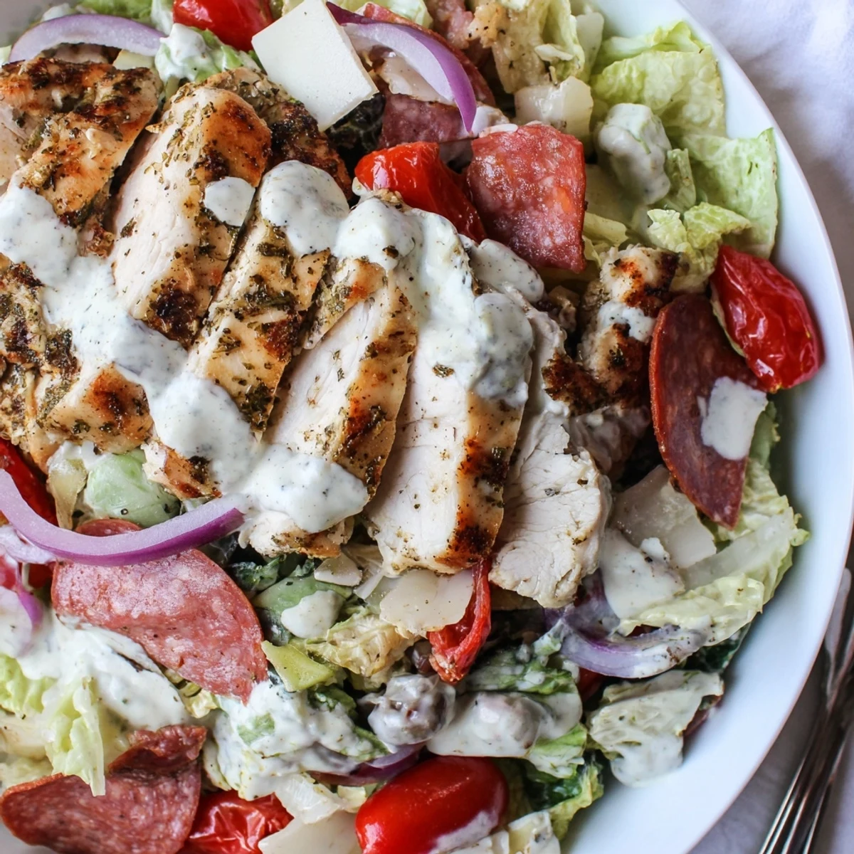 Hearty Italian Grinder Chicken Salad layered with salami provolone pepperoncini and zesty herb dressing